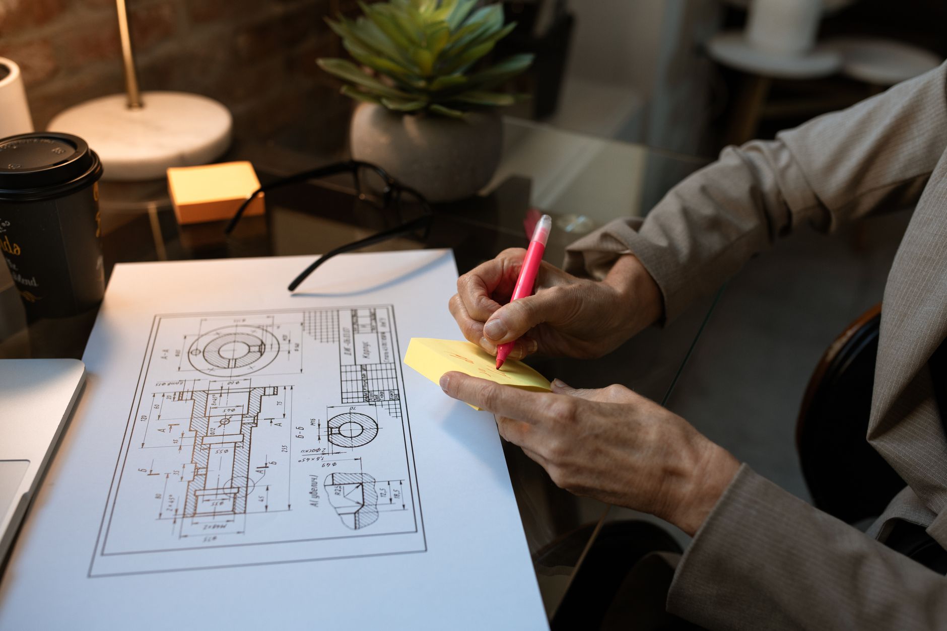 A small business owner planning their marketing at a workshop desk