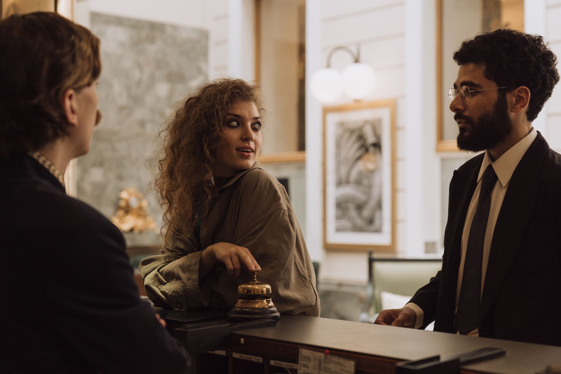 A receptionist welcoming a visitor into a small solicitors' office