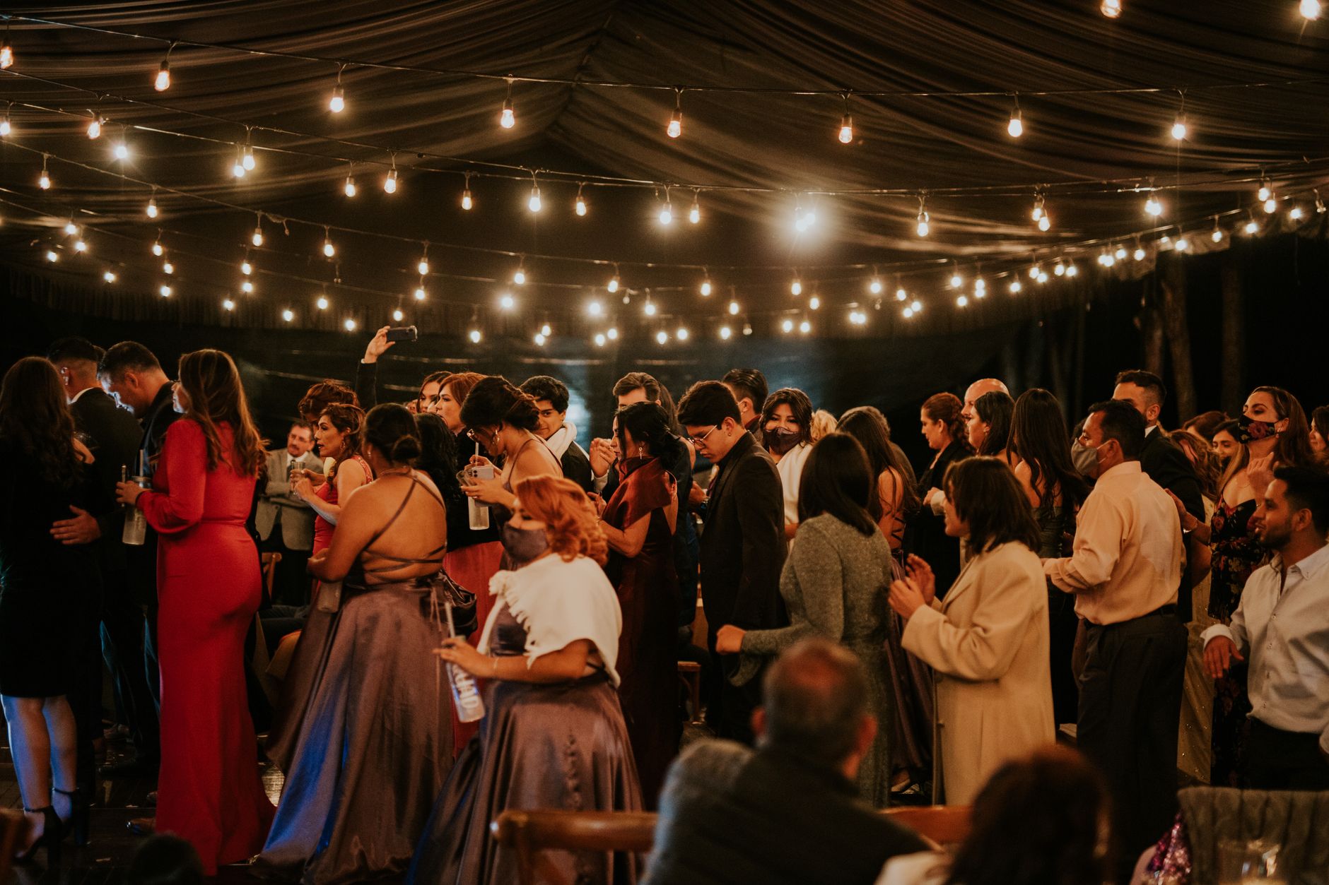 Real wedding guests dancing at an evening reception