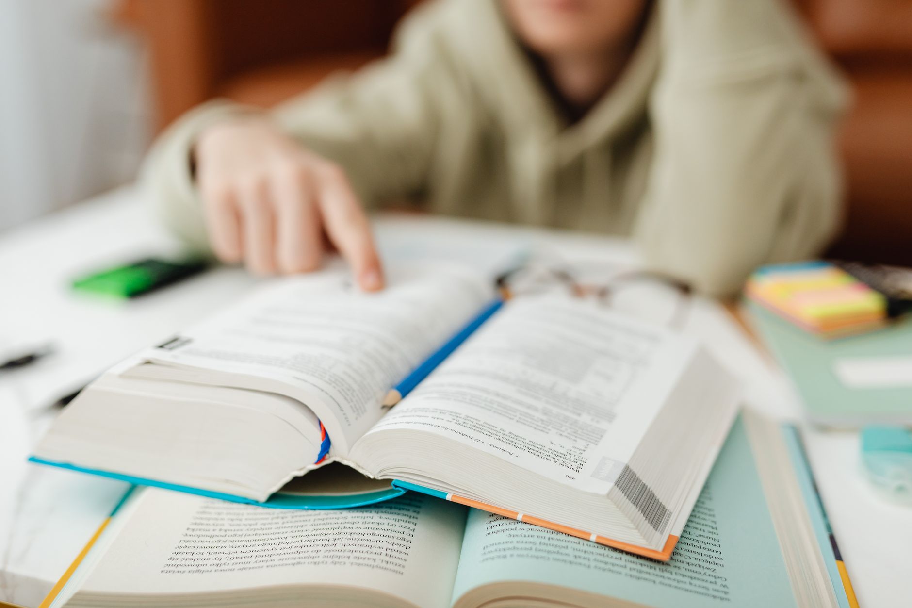 A business owner reading up on marketing fundamentals at a desk