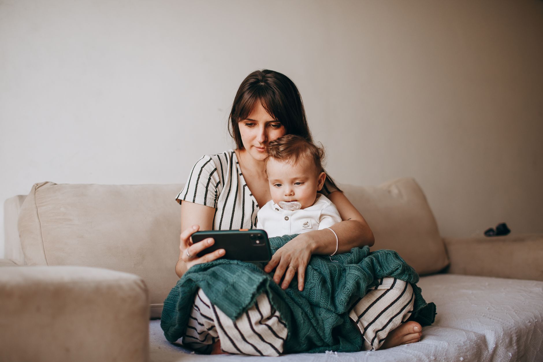A new mother following a postnatal exercise video at home