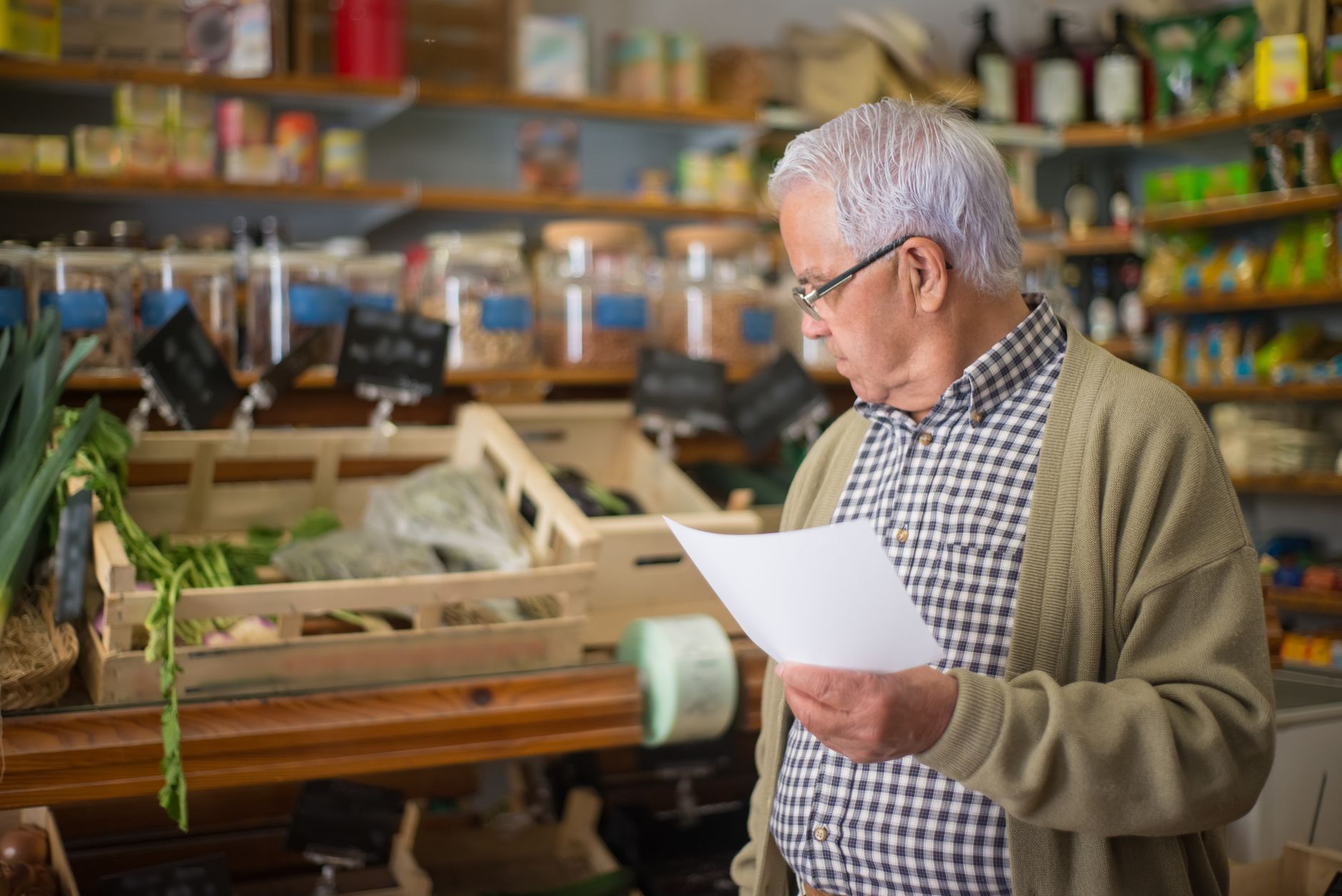 A shop owner reading through the sections of a marketing plan template
