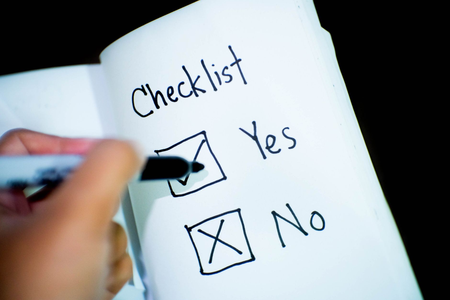 A business owner ticking off steps while completing their plan