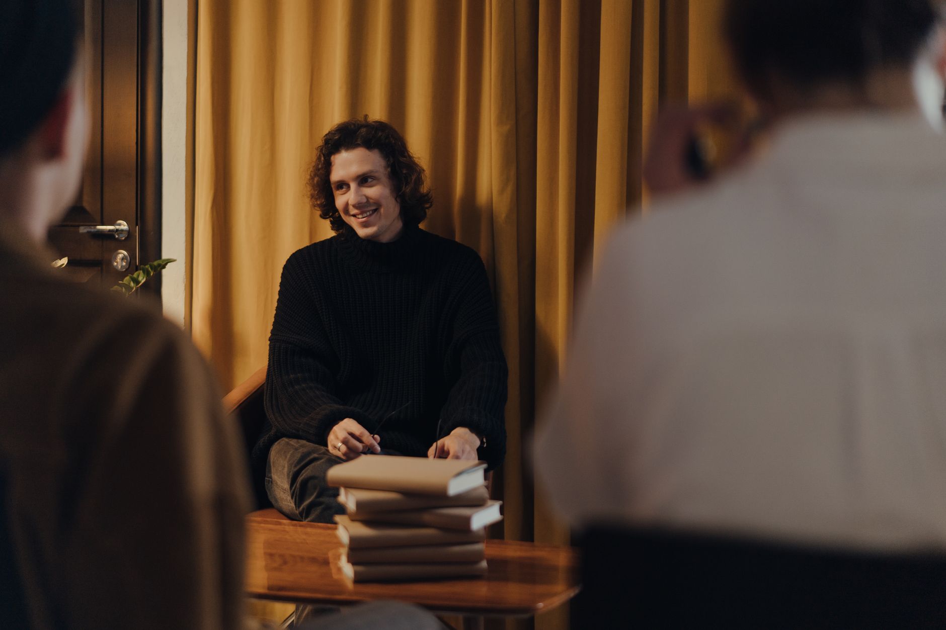 A bookshop owner preparing for an author evening event