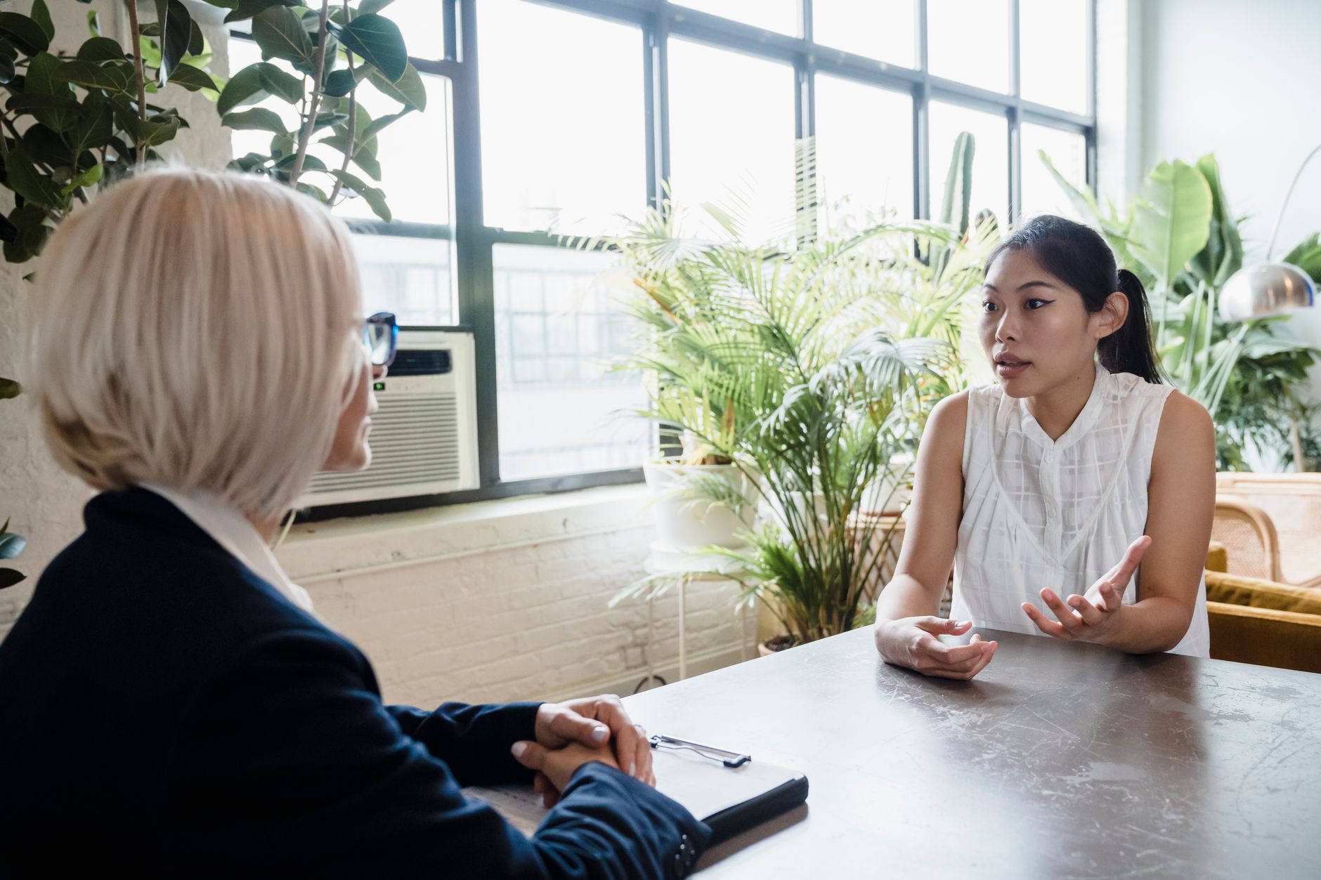 A coach in conversation with a client across a small table