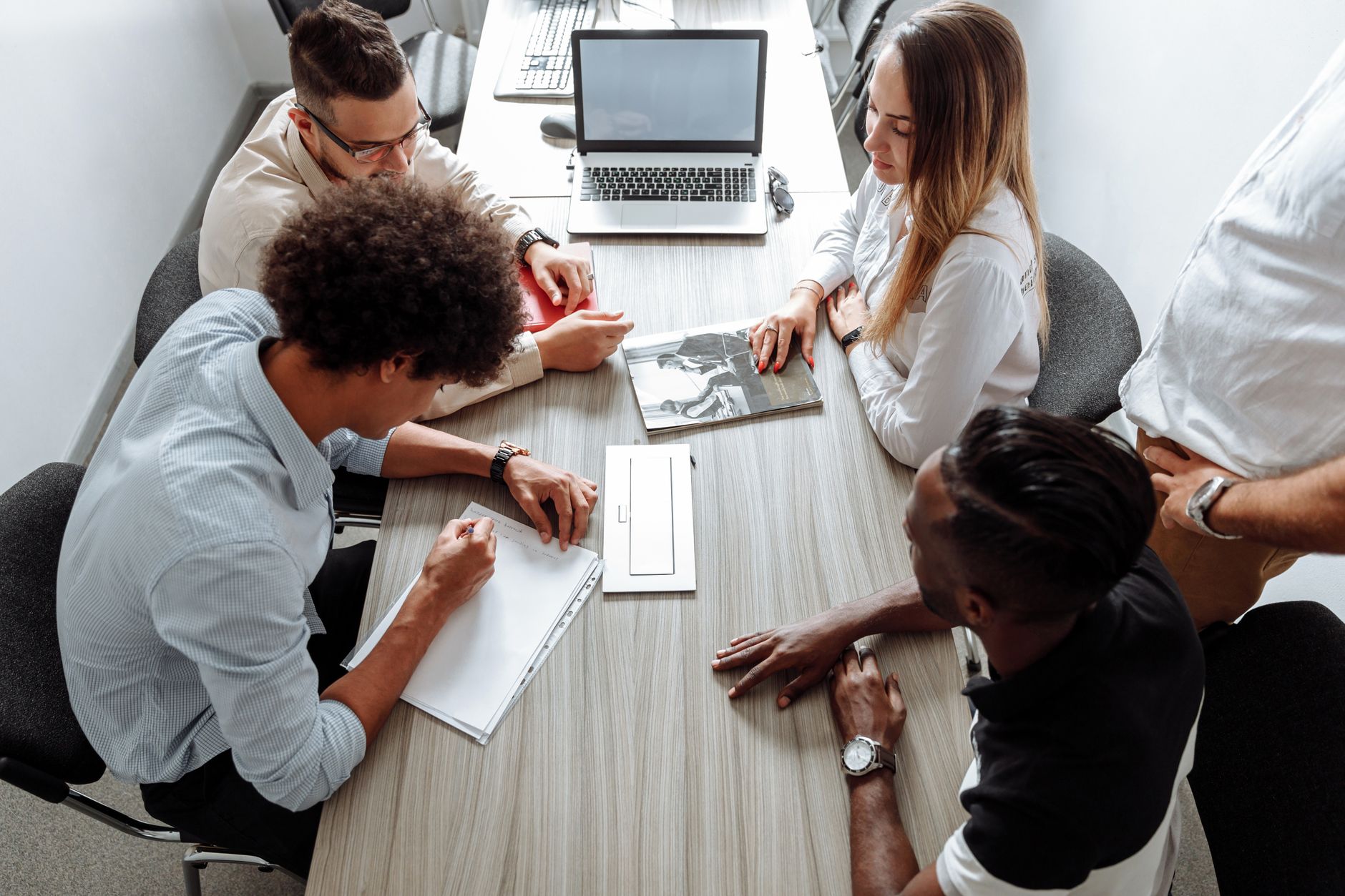A small team discussing their product together around an office desk