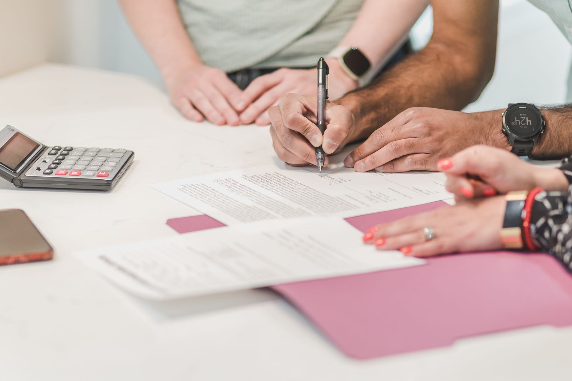 A course creator filling in a marketing plan by hand at her kitchen table