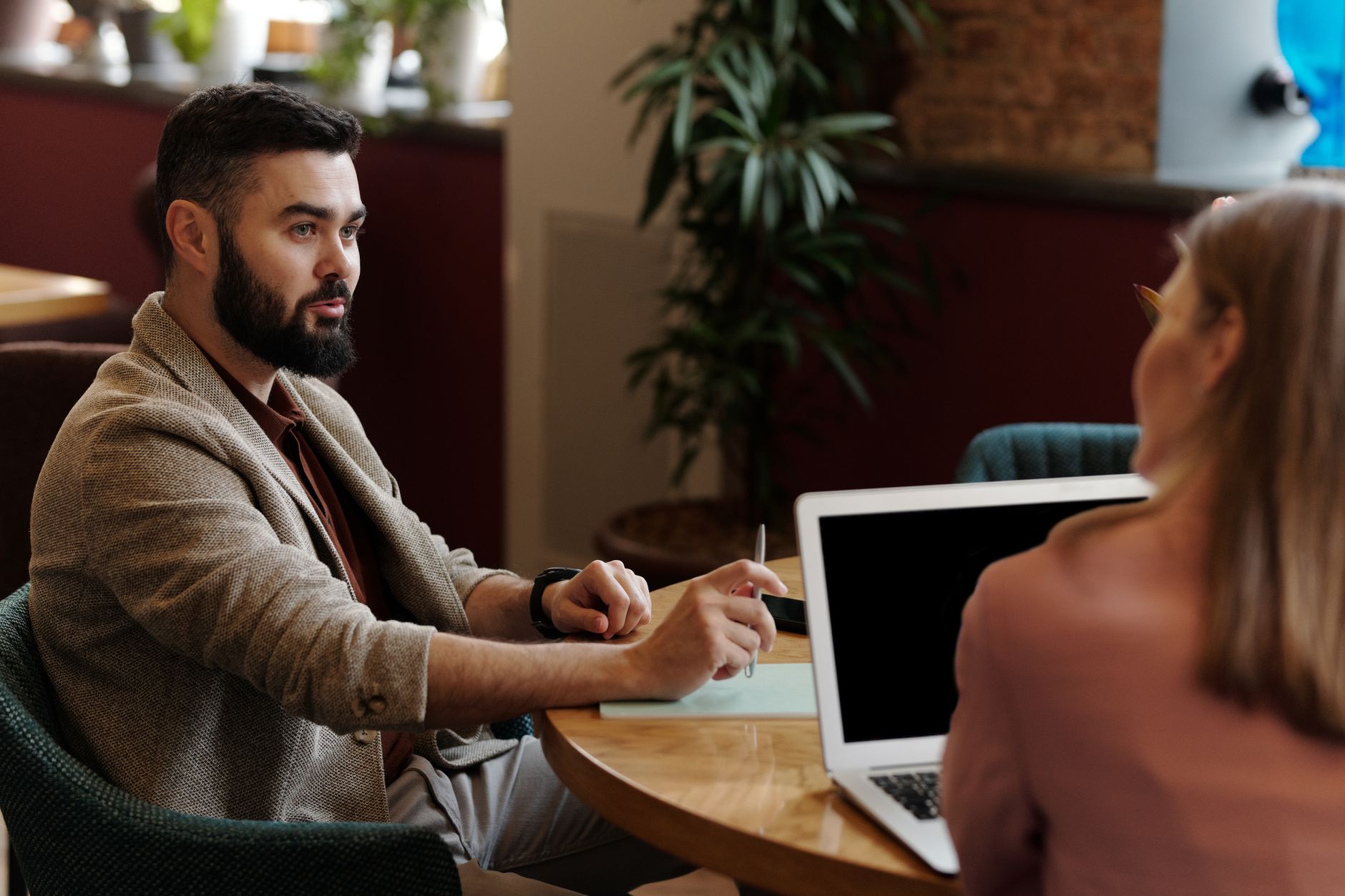 Two course creators comparing their marketing choices over coffee