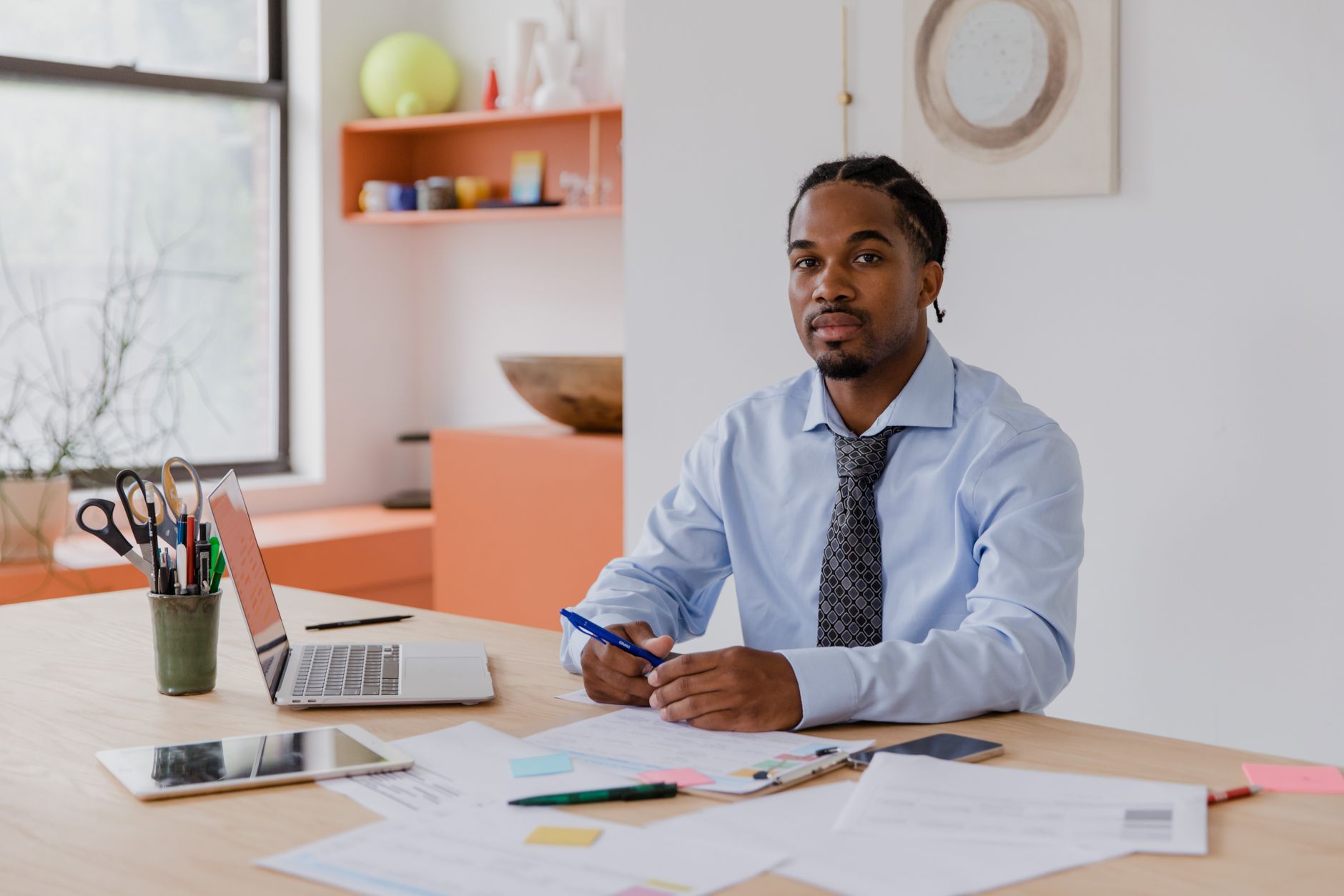 A small business owner drafting a marketing plan on one page