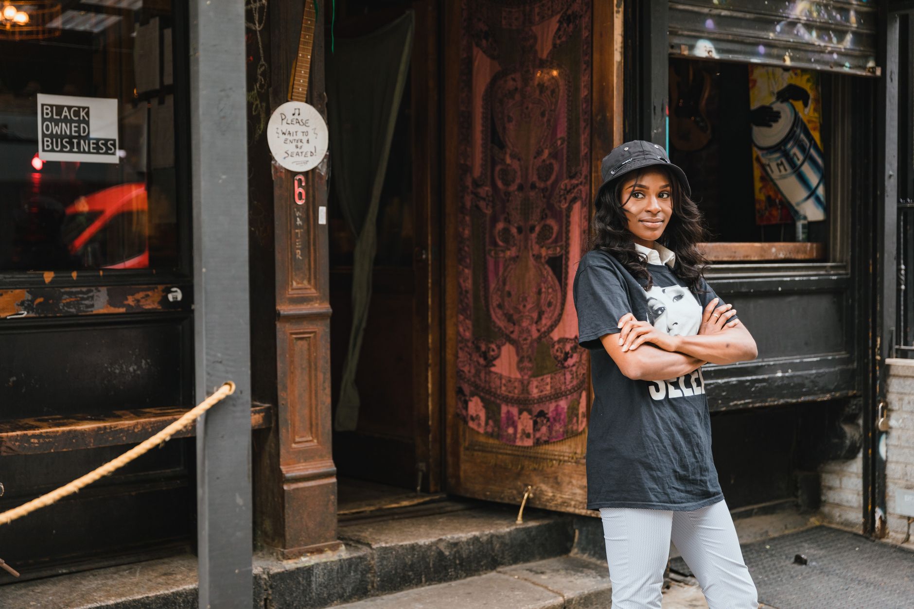A small business owner standing confidently in their own business