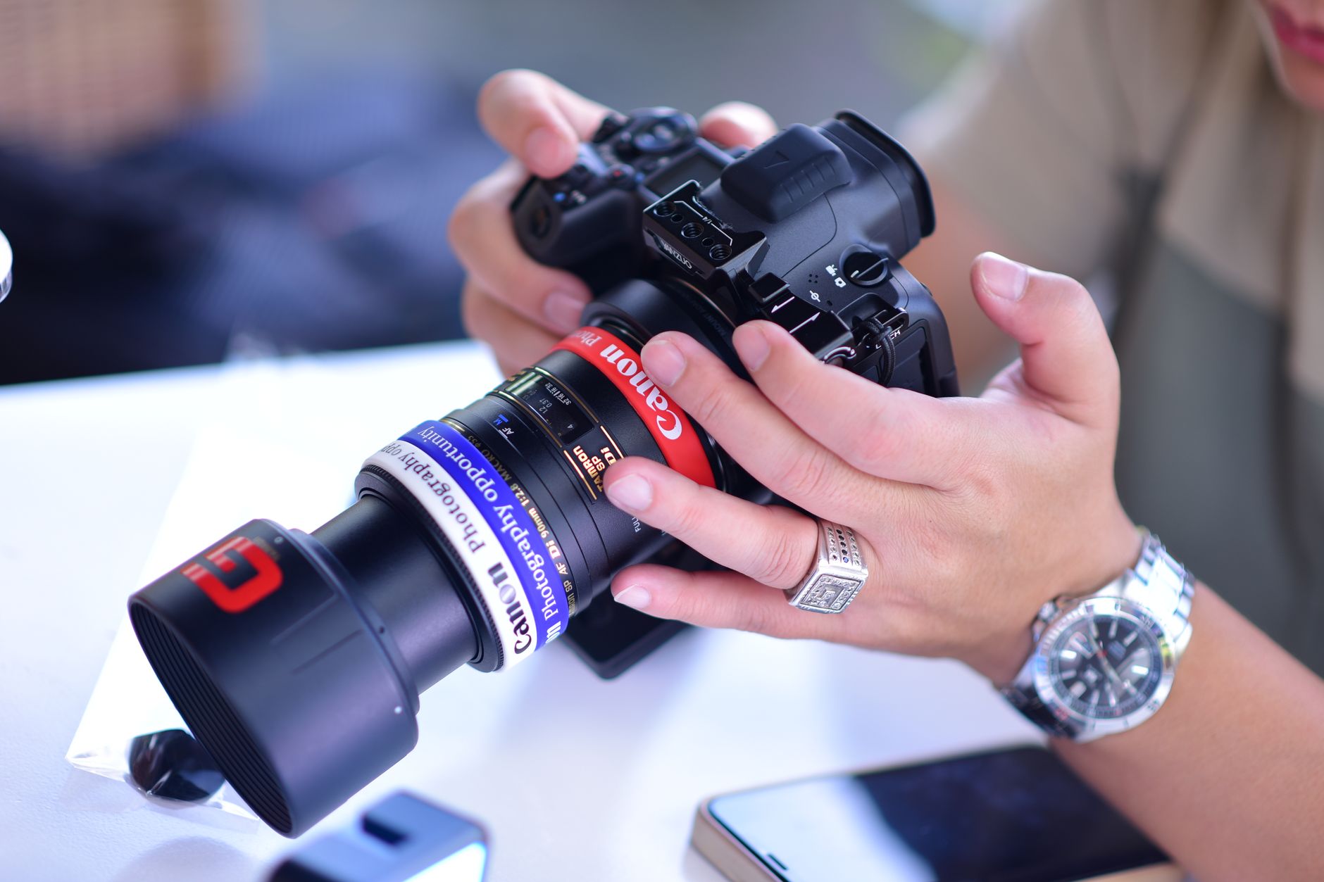 A jeweller taking a close-up macro photo of a ring