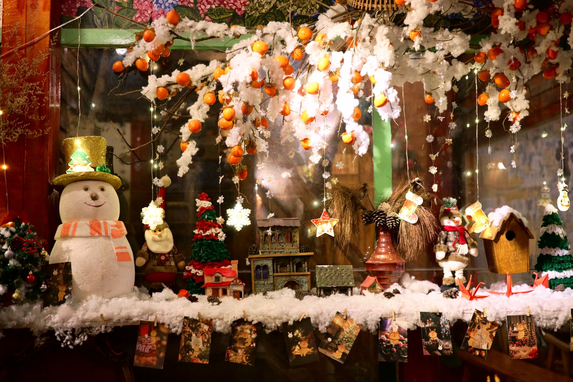 A shop assistant refreshing a seasonal window display
