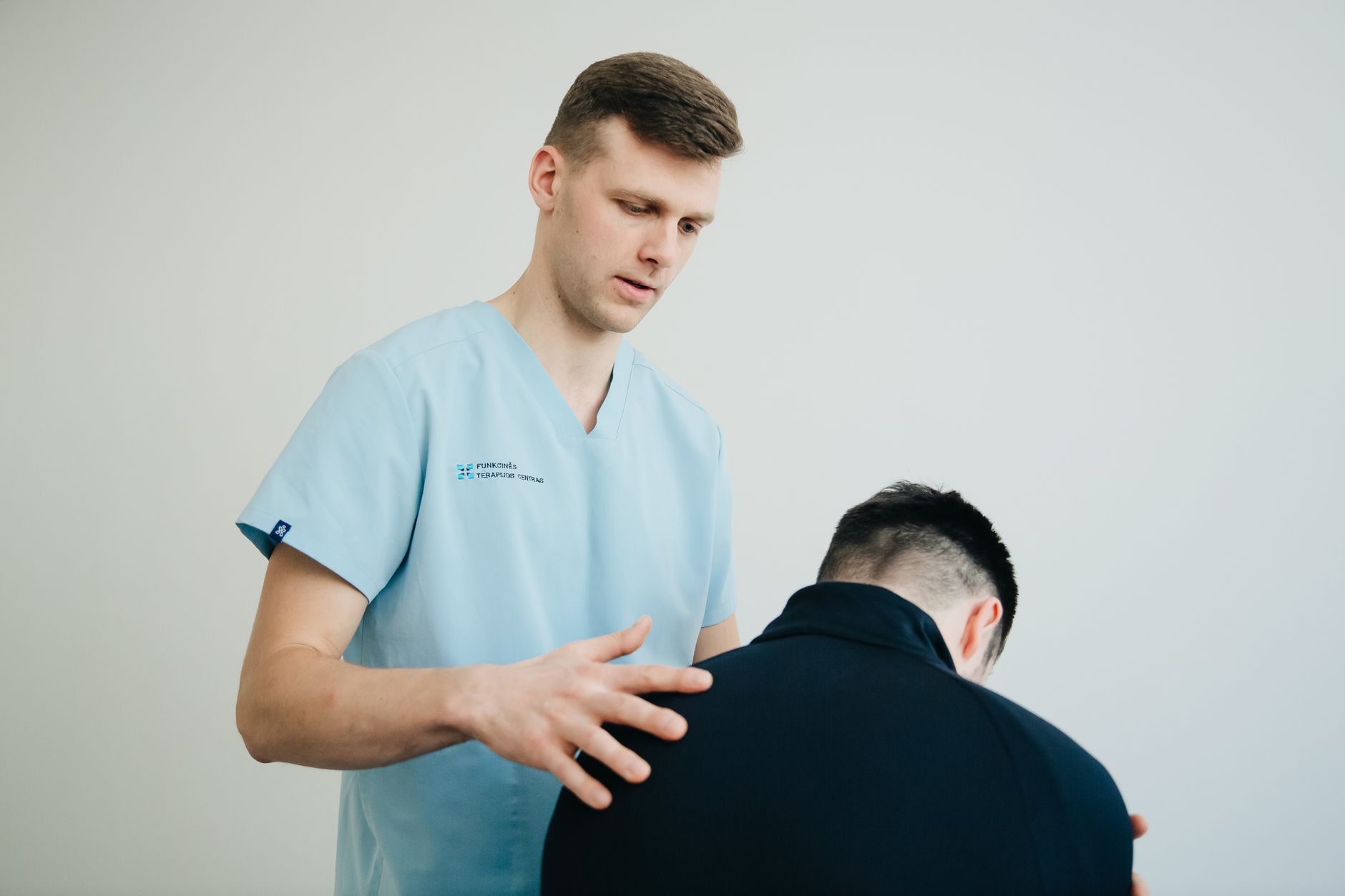 A physiotherapist standing in a recently updated clinic reception
