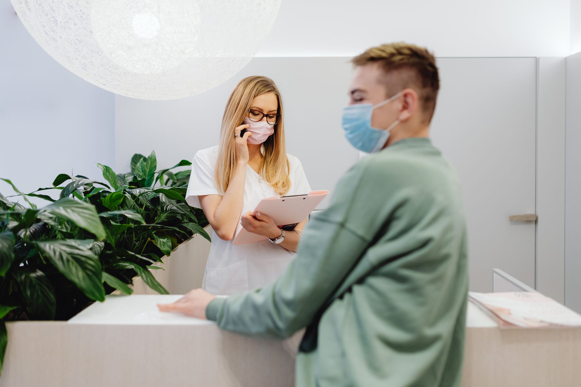 A receptionist clarifying what the practice offers to a new caller