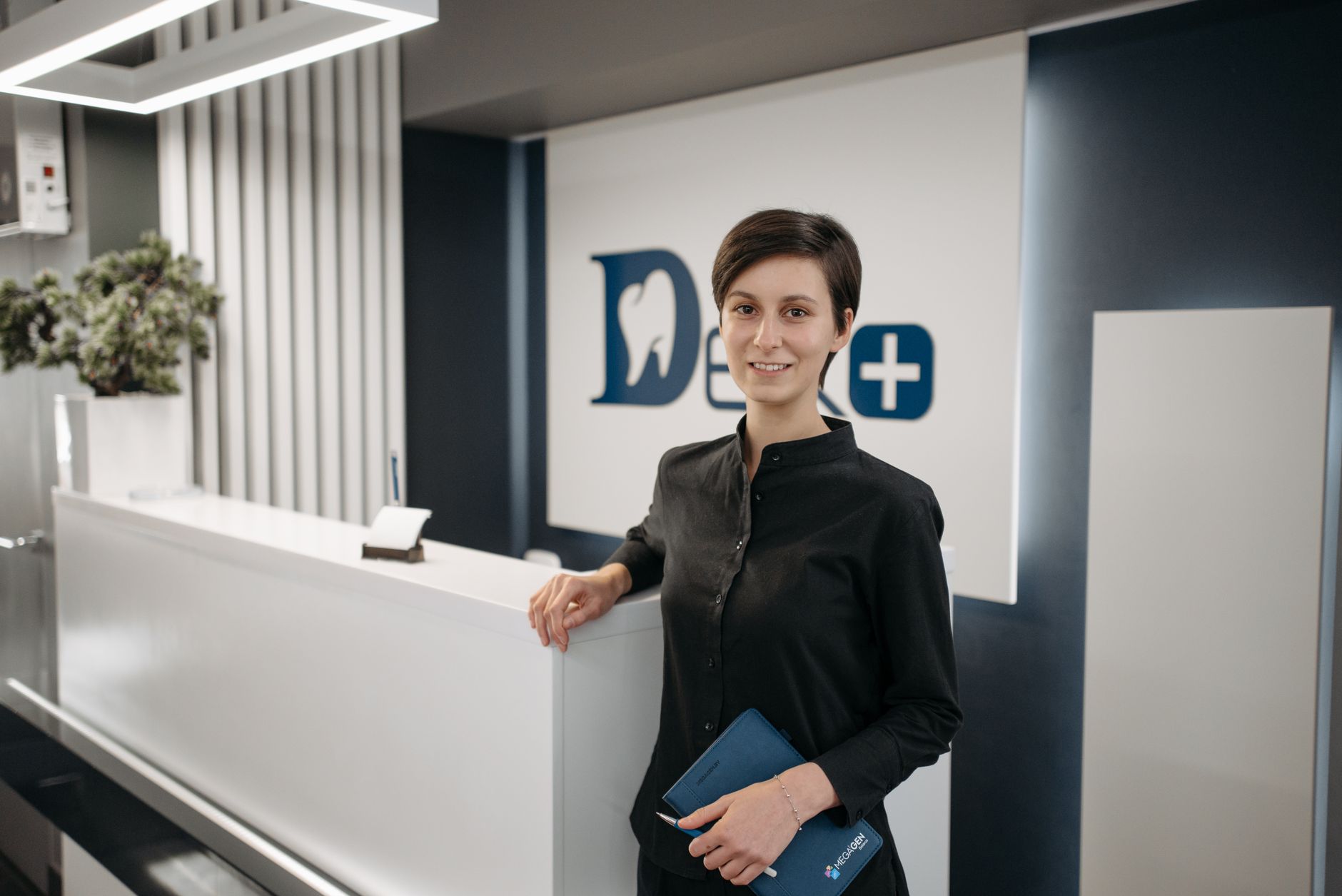 A returning patient greeted warmly by a receptionist she recognises