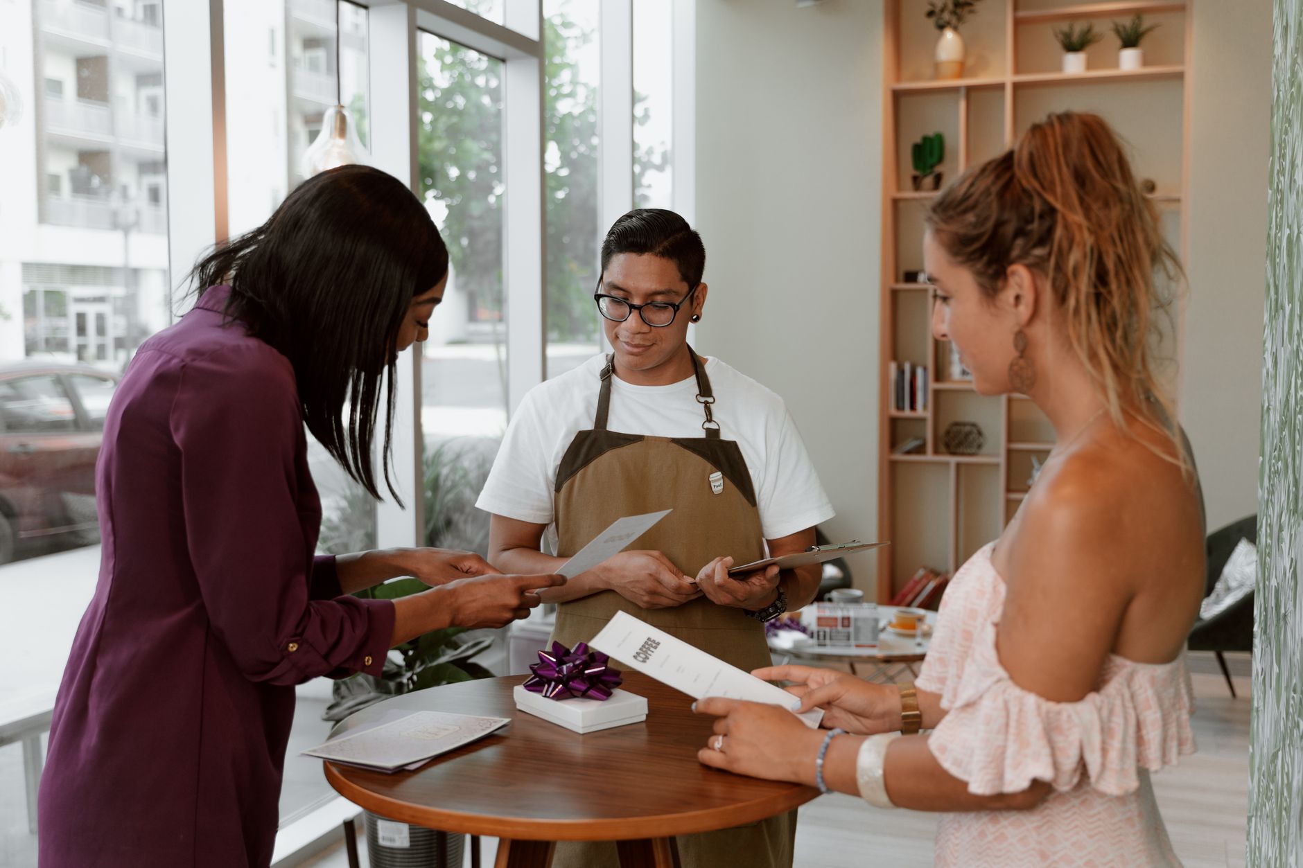 A waiter welcoming back a regular customer by name