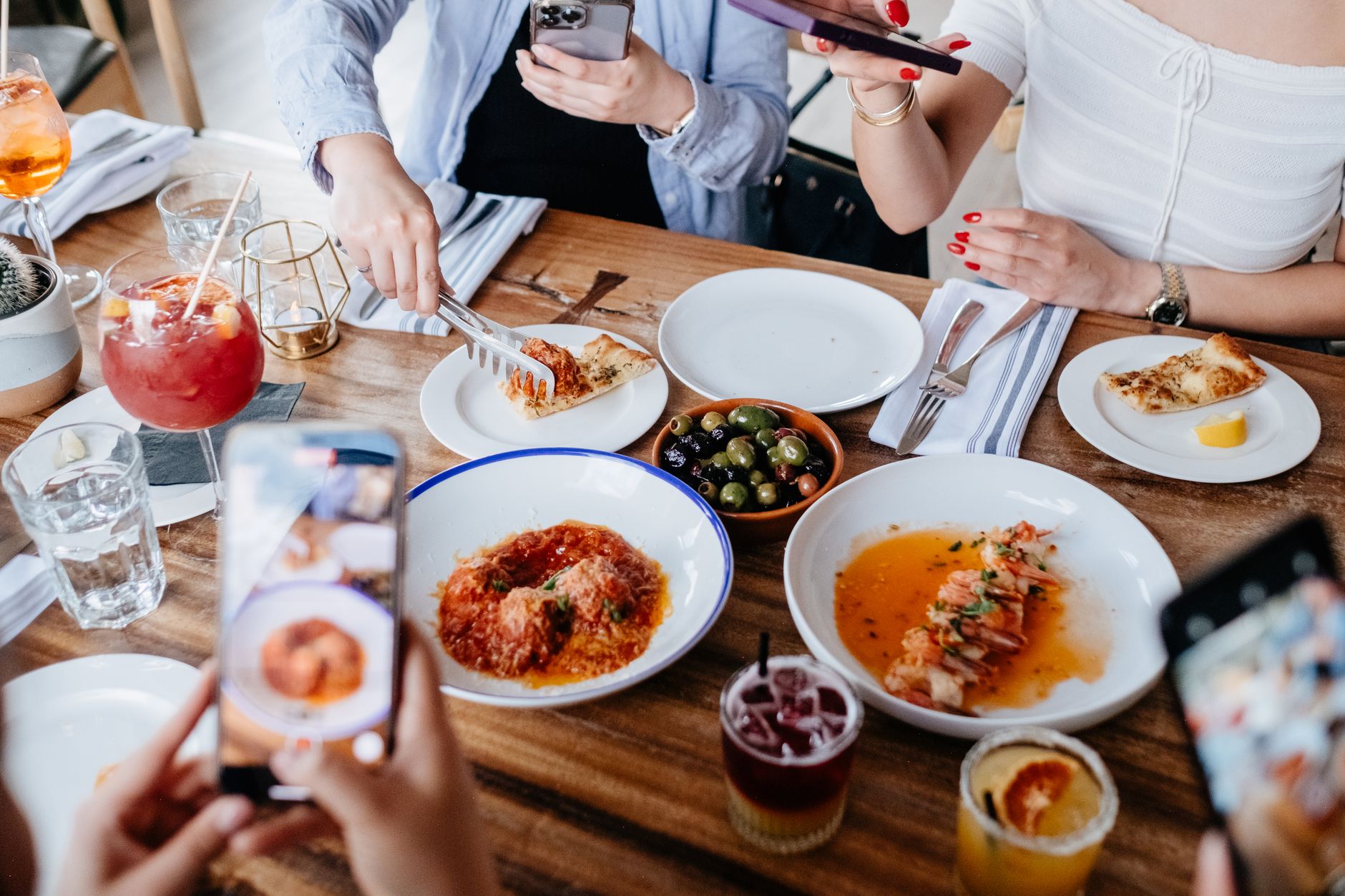 Friends photographing a distinctive dish before eating