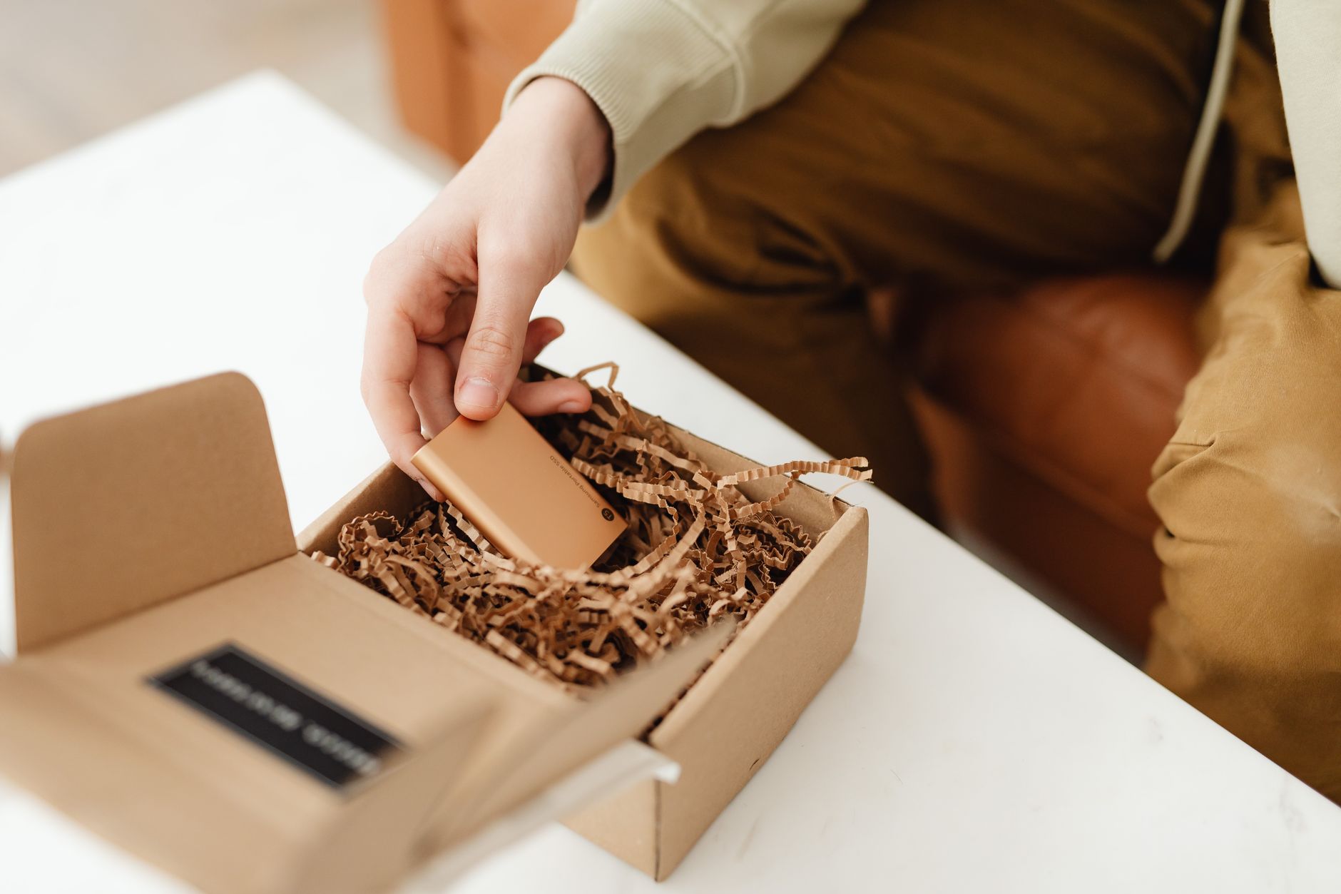 A shop assistant wrapping a purchase in the shop's recognisable packaging