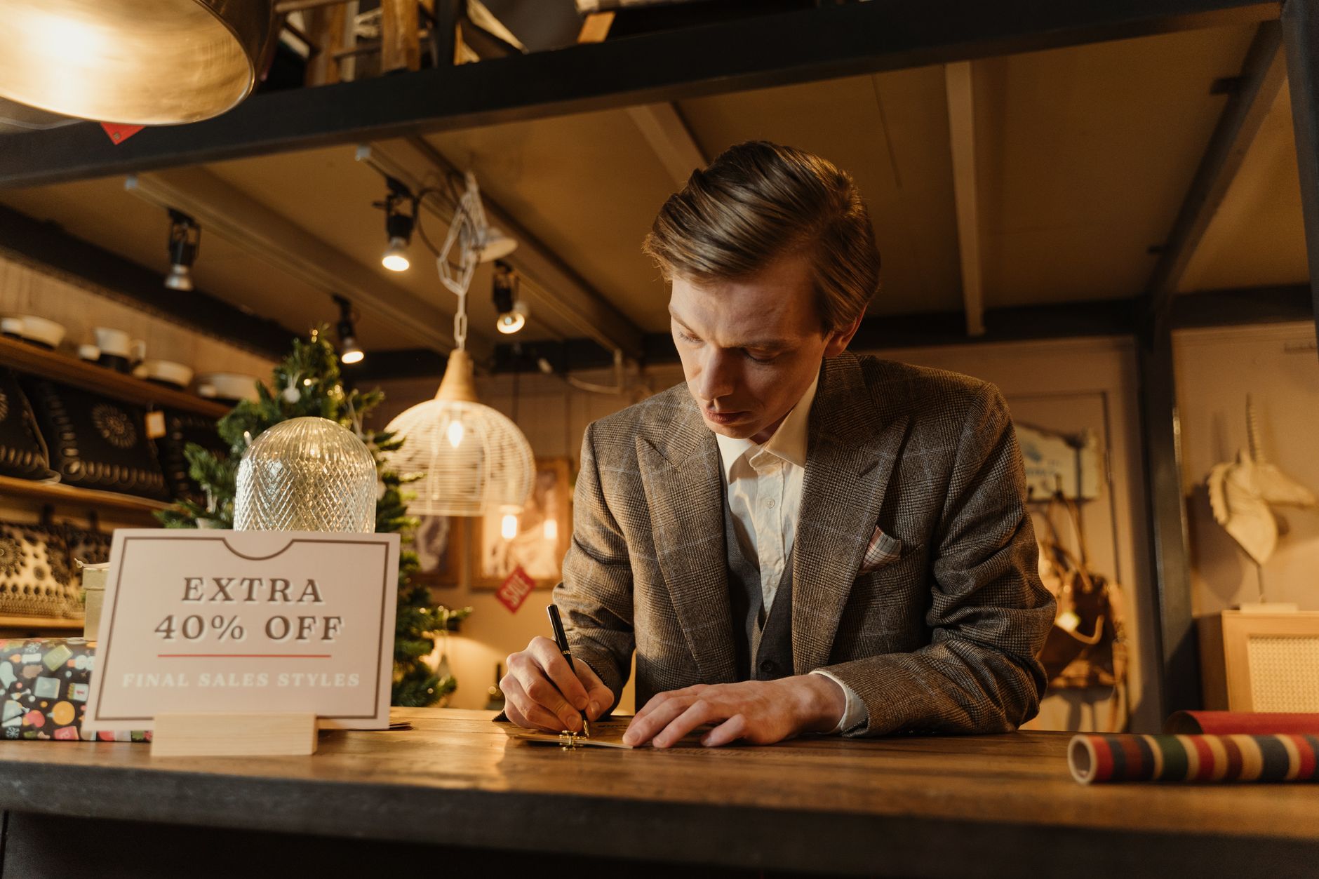 A shop owner preparing a planned seasonal promotion sign