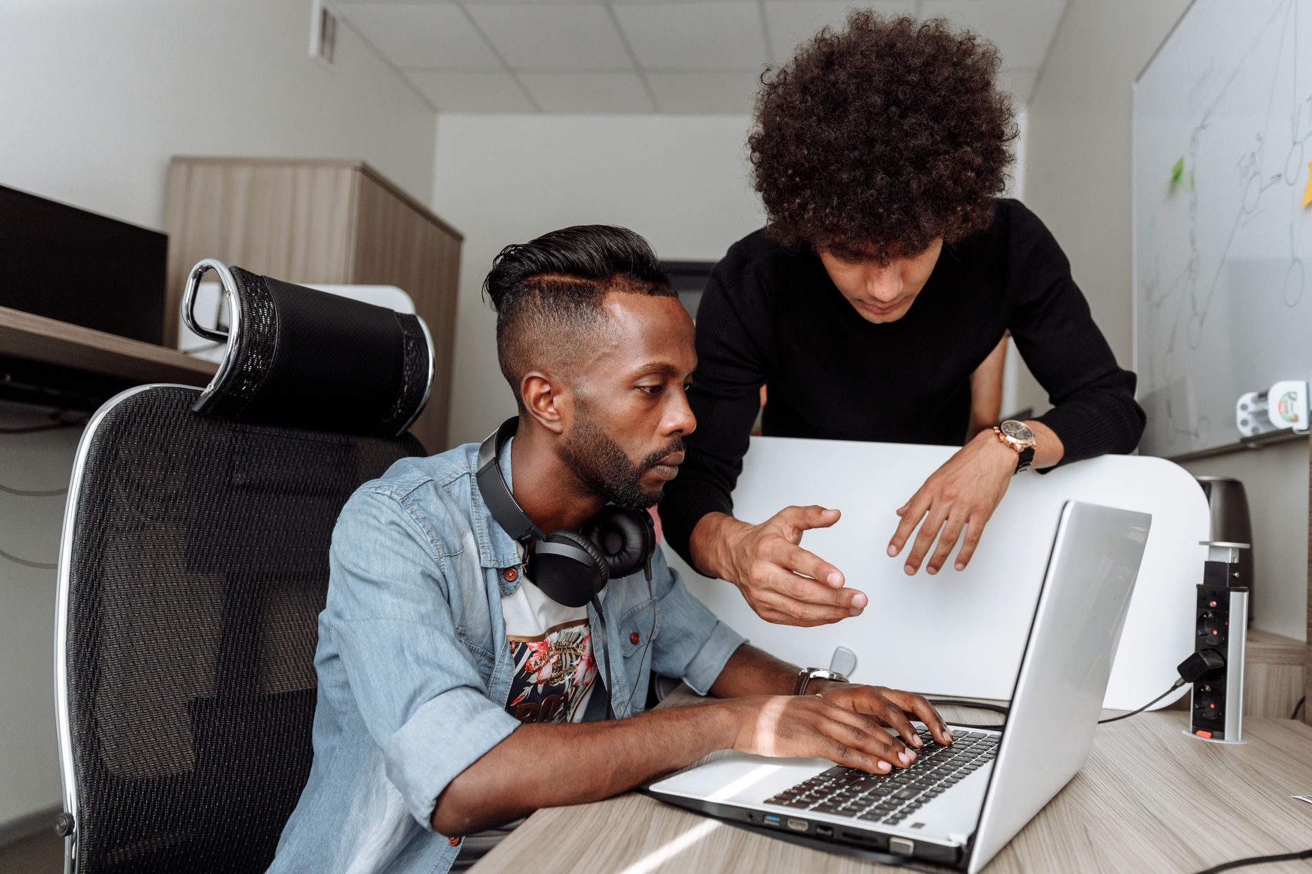 A colleague walking a new user through their first real task