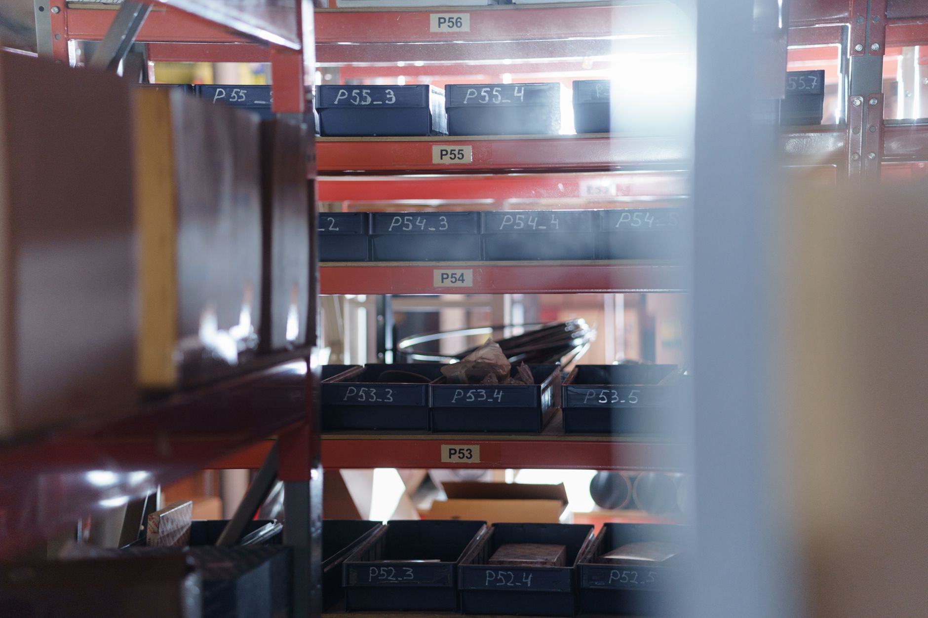 An owner organising stock by category in a small stockroom