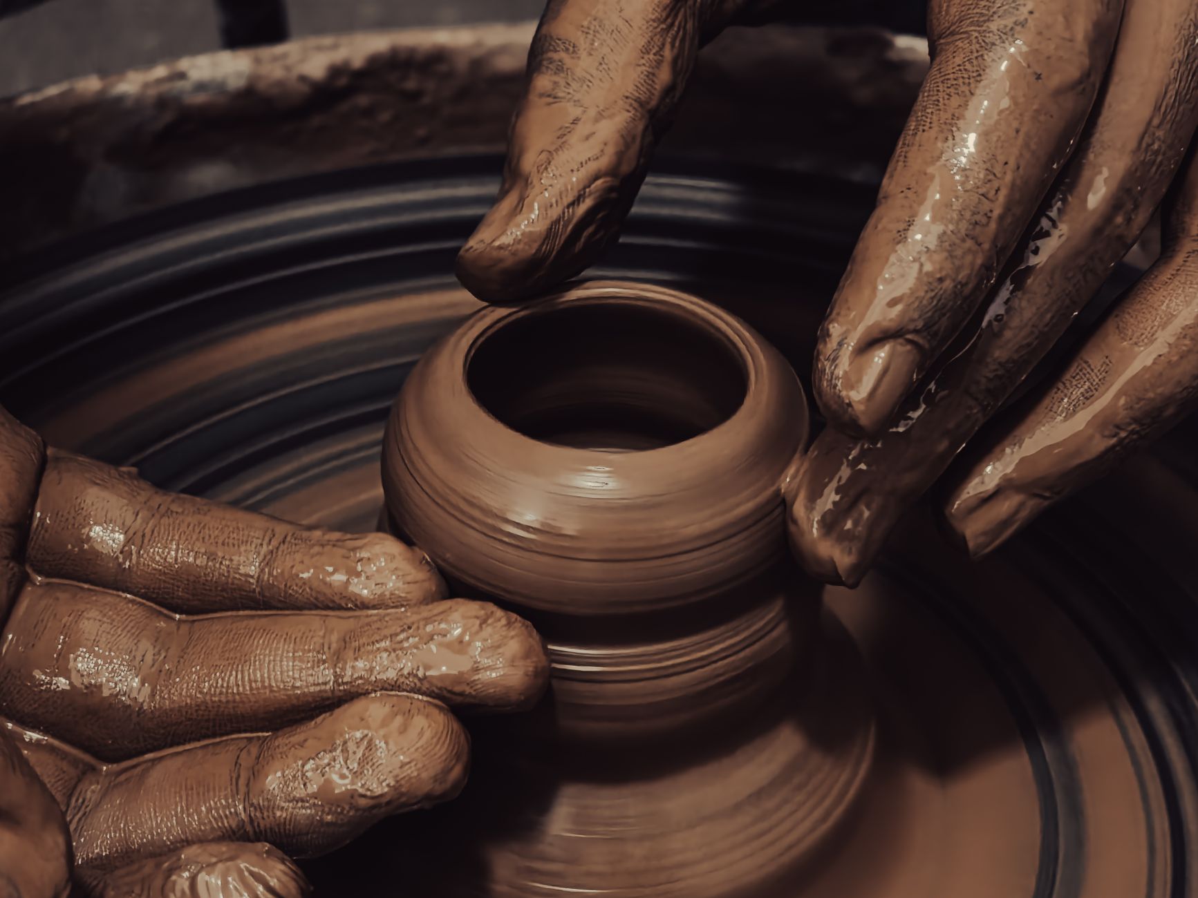 A potter writing a handwritten tag for a finished piece