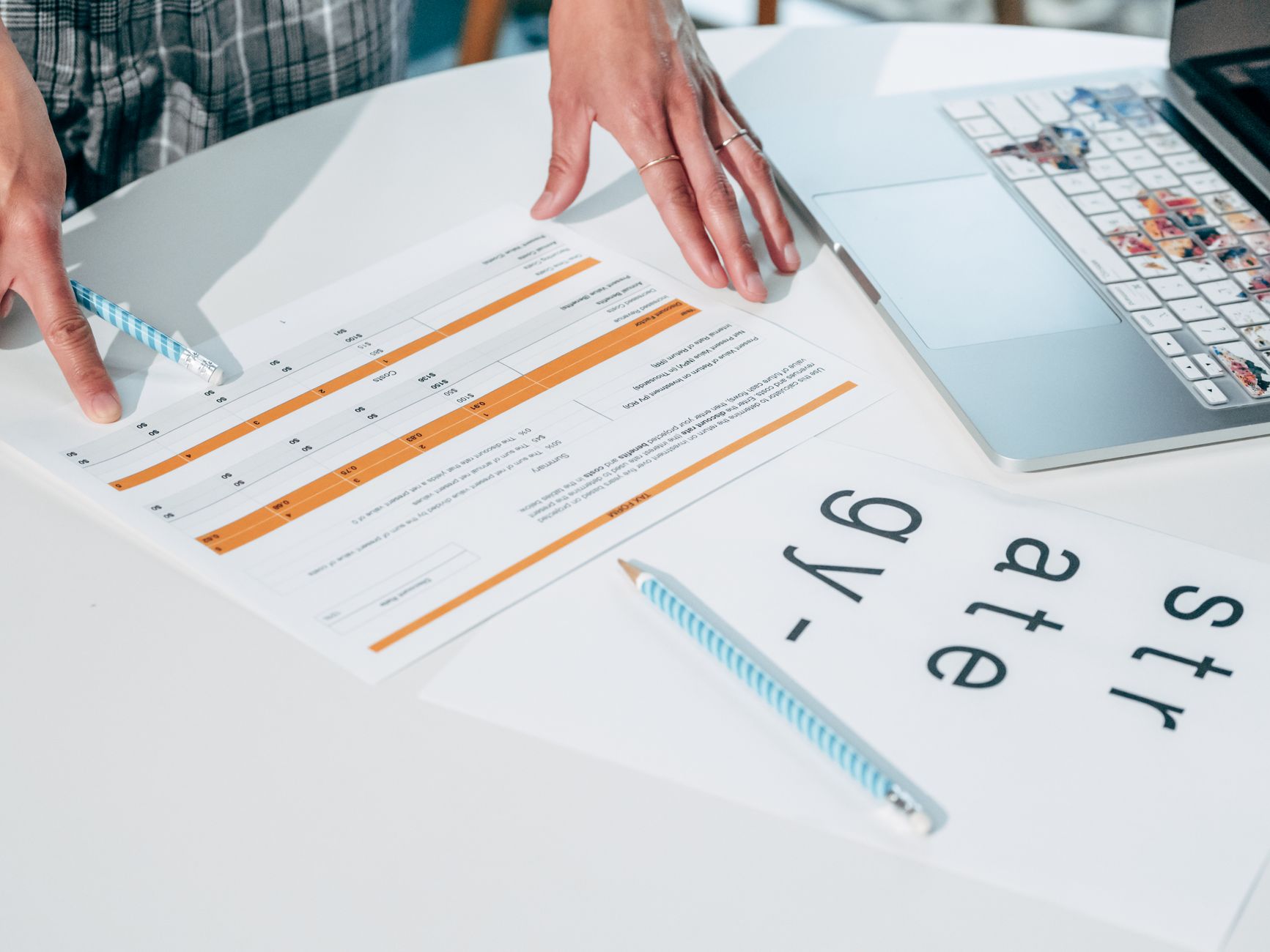An illustrator checking a consistent line across printed materials