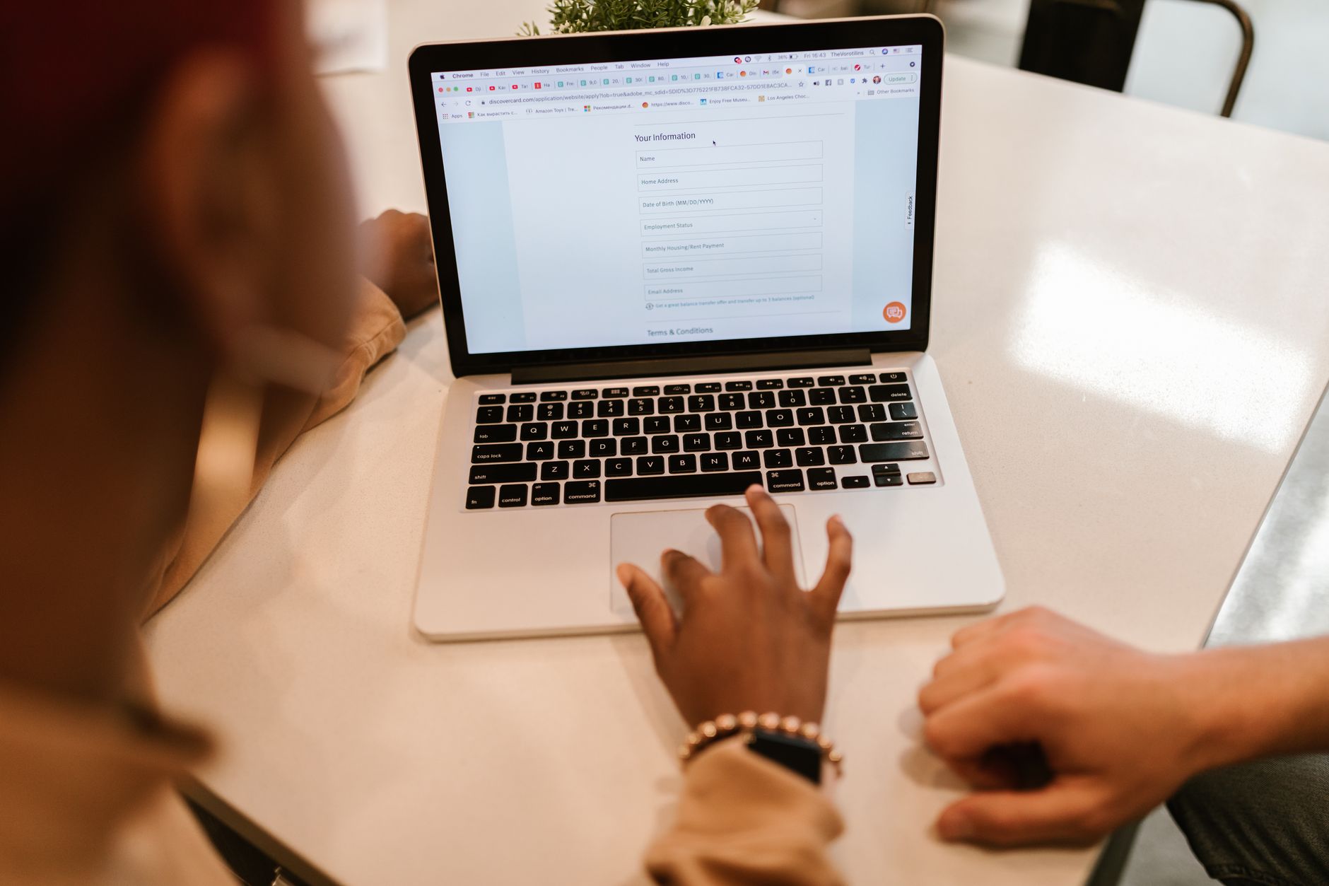 A customer completes a quick online booking on a laptop, tapping through a clean two-step form with no clutter on the screen.