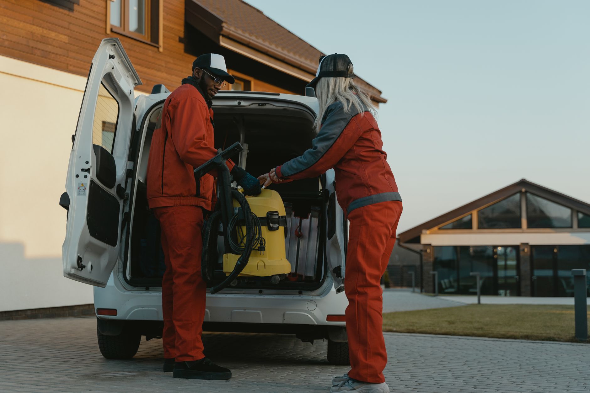 A home cleaning business owner stands smiling beside her branded van, the kind of owner-and-face post that builds recognition.