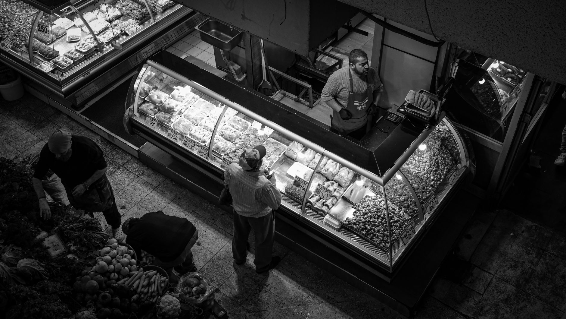 A family buying picnic supplies at a local grocer