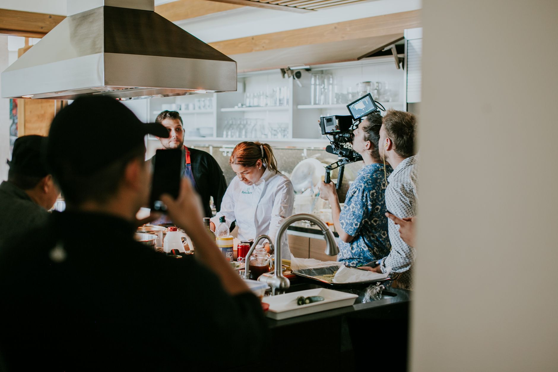 A business owner filming a short video for social media in their kitchen