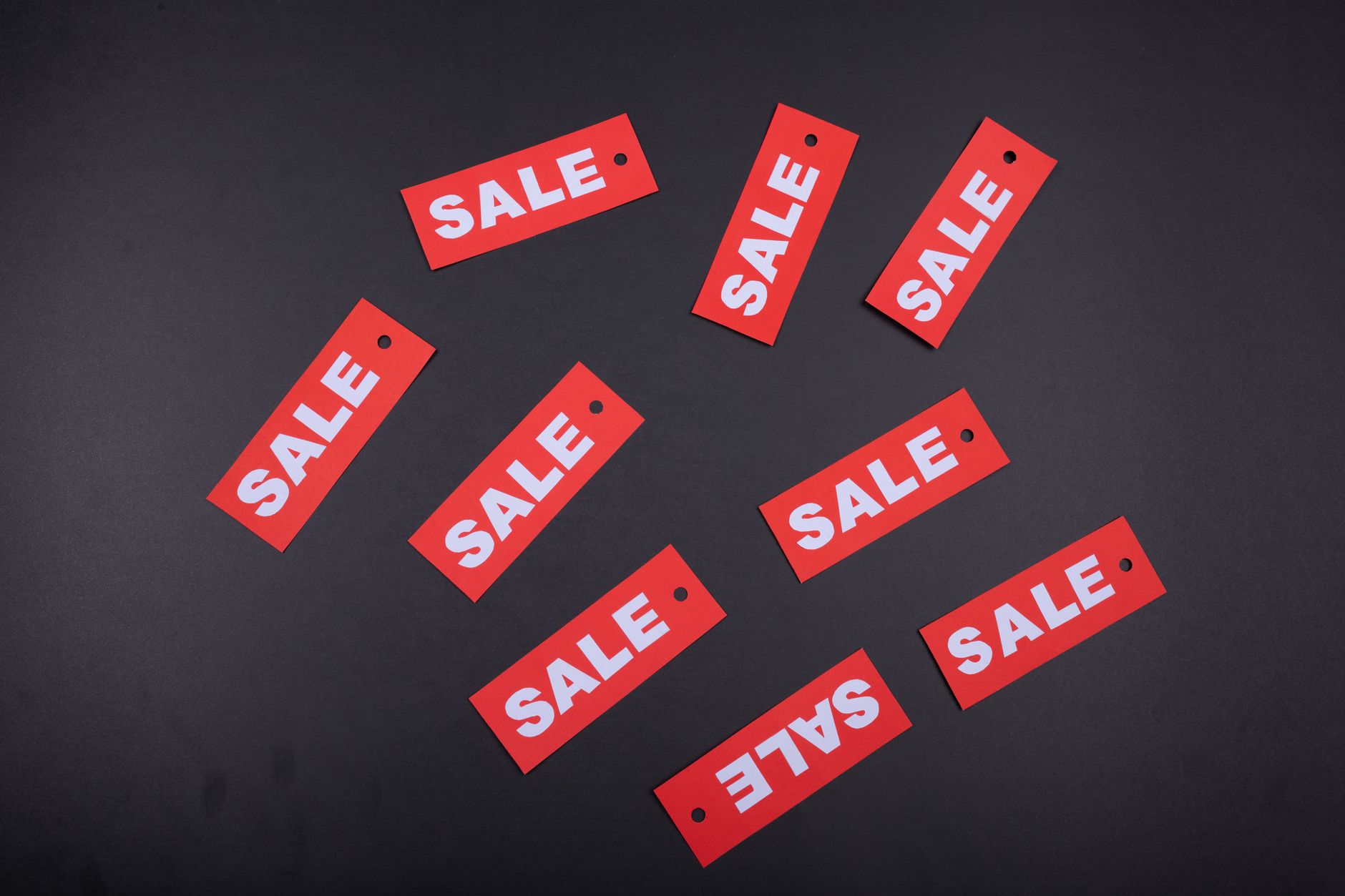 A shop owner reviewing leftover seasonal stock and discount signage