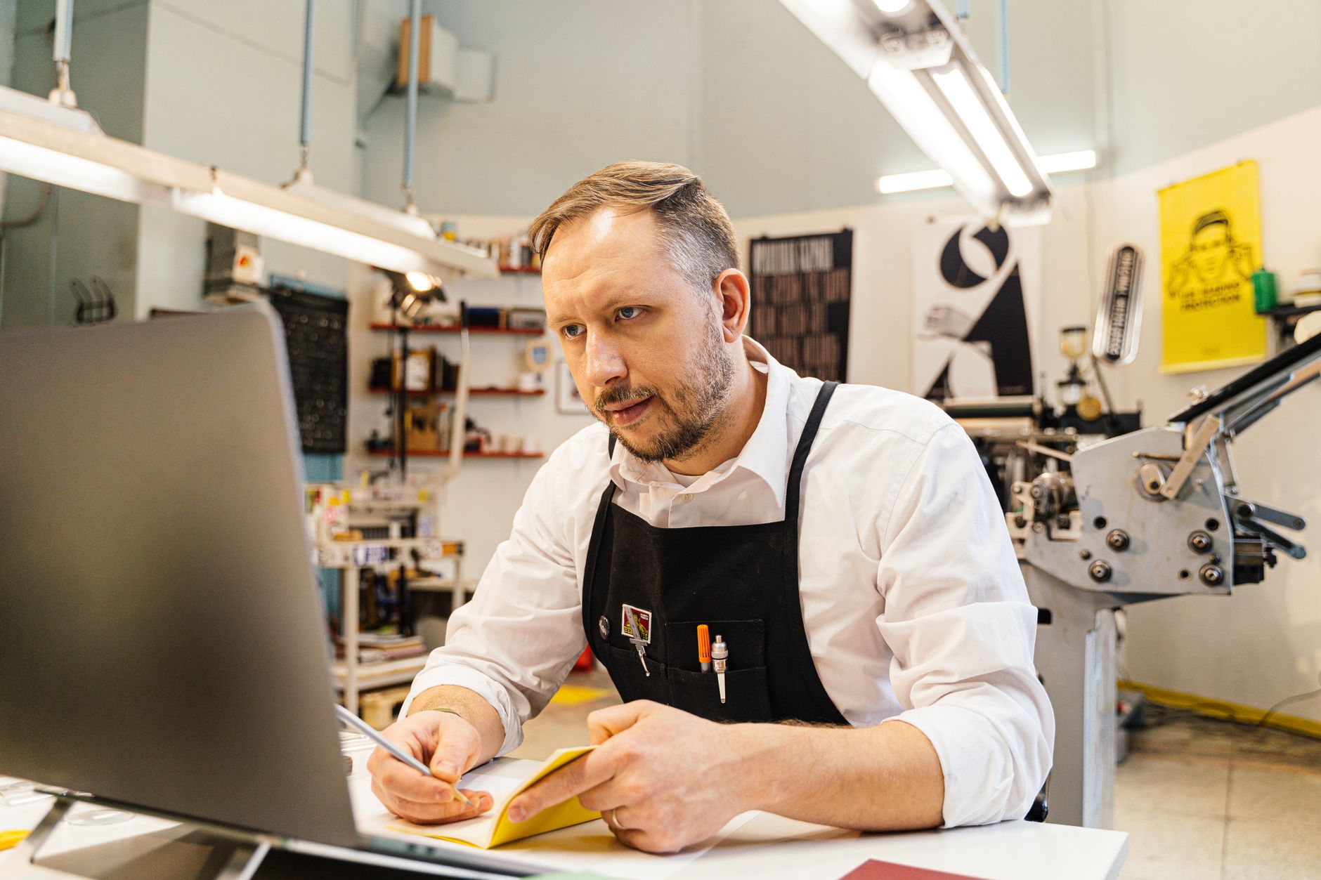 A shop owner sorting notes into four categories at the counter