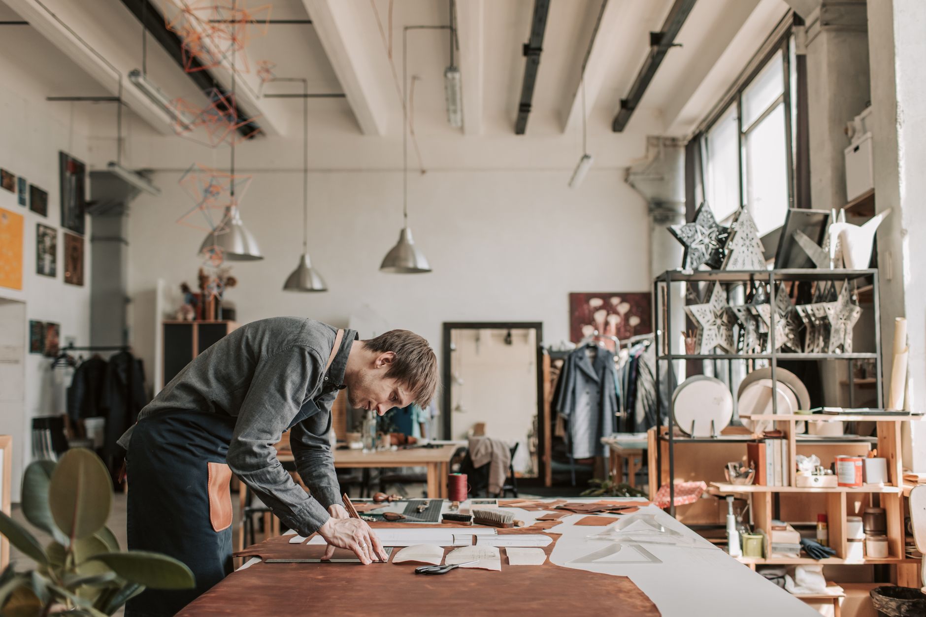A maker standing among a small, carefully chosen body of finished work