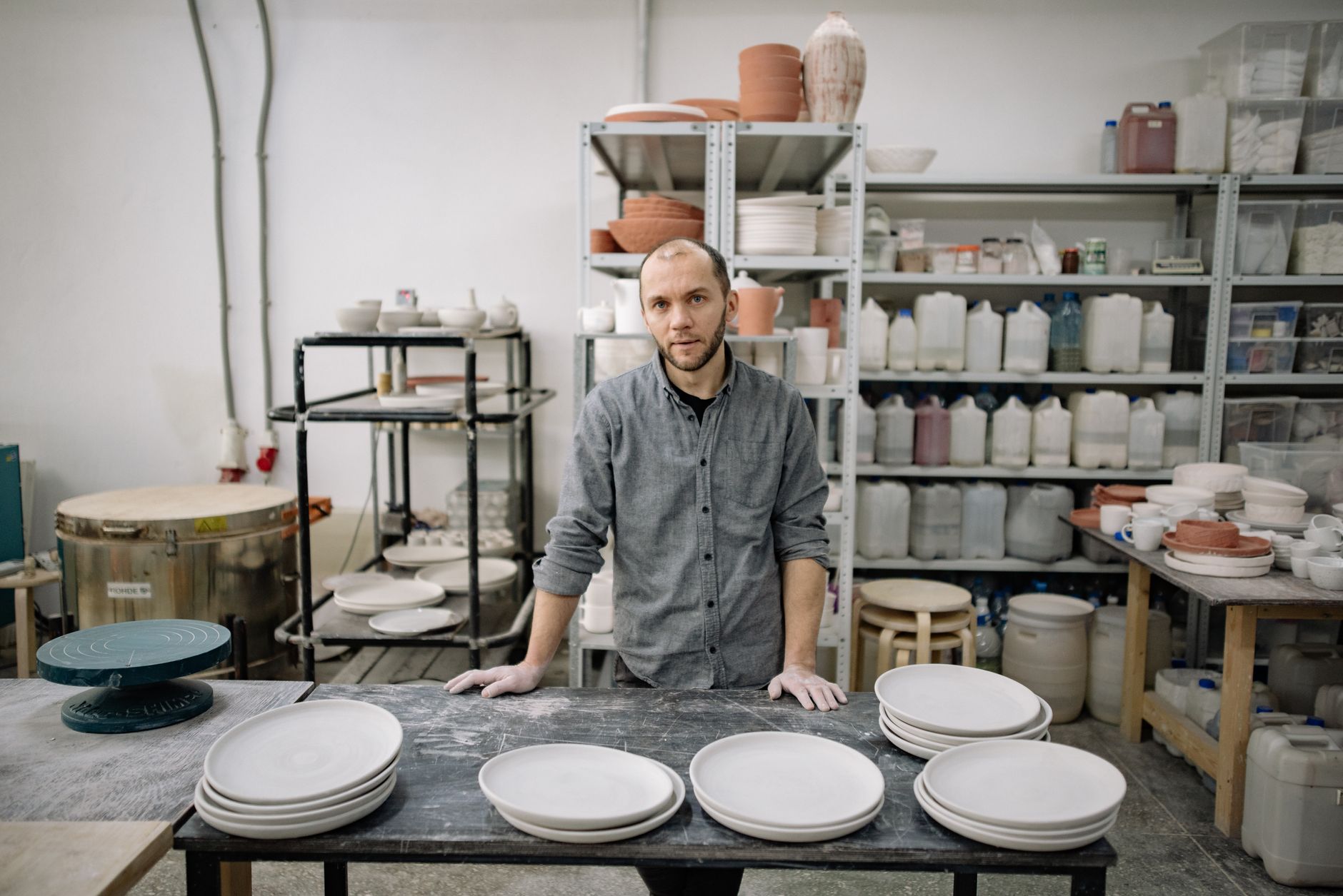 A ceramicist inspecting a finished piece with careful attention