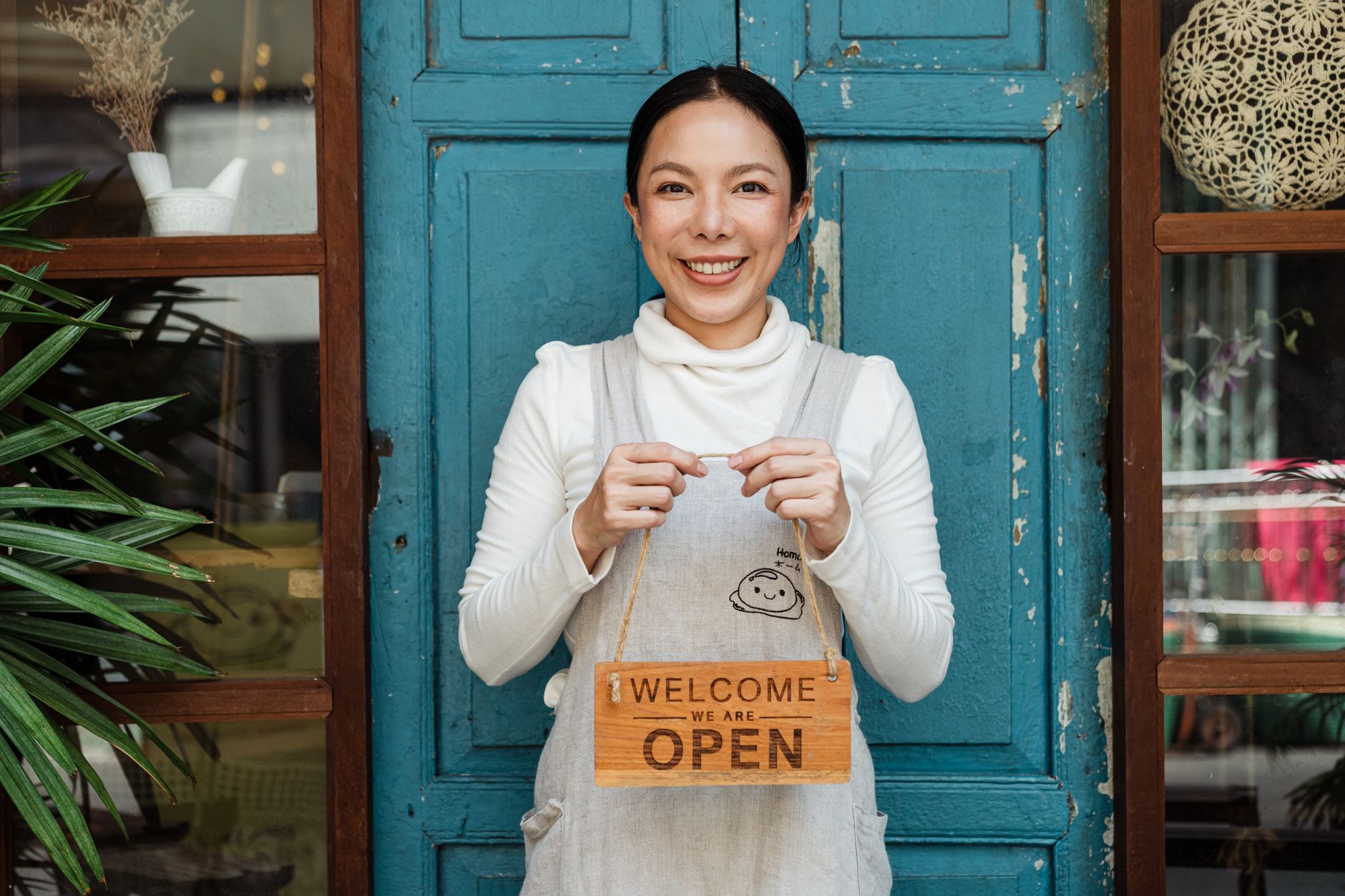 A small business owner standing confidently in their business