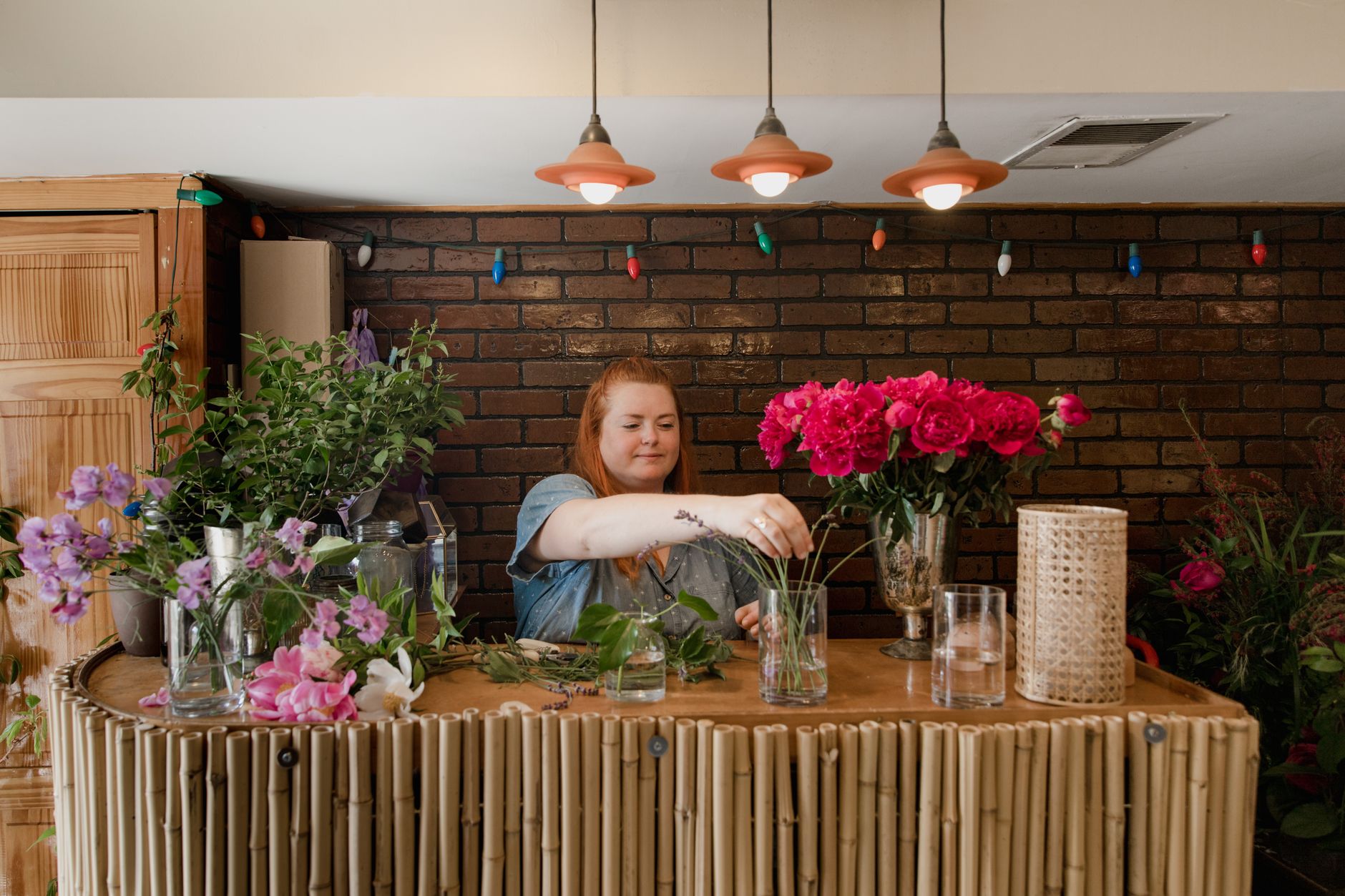 A florist taking care over one piece of work rather than many