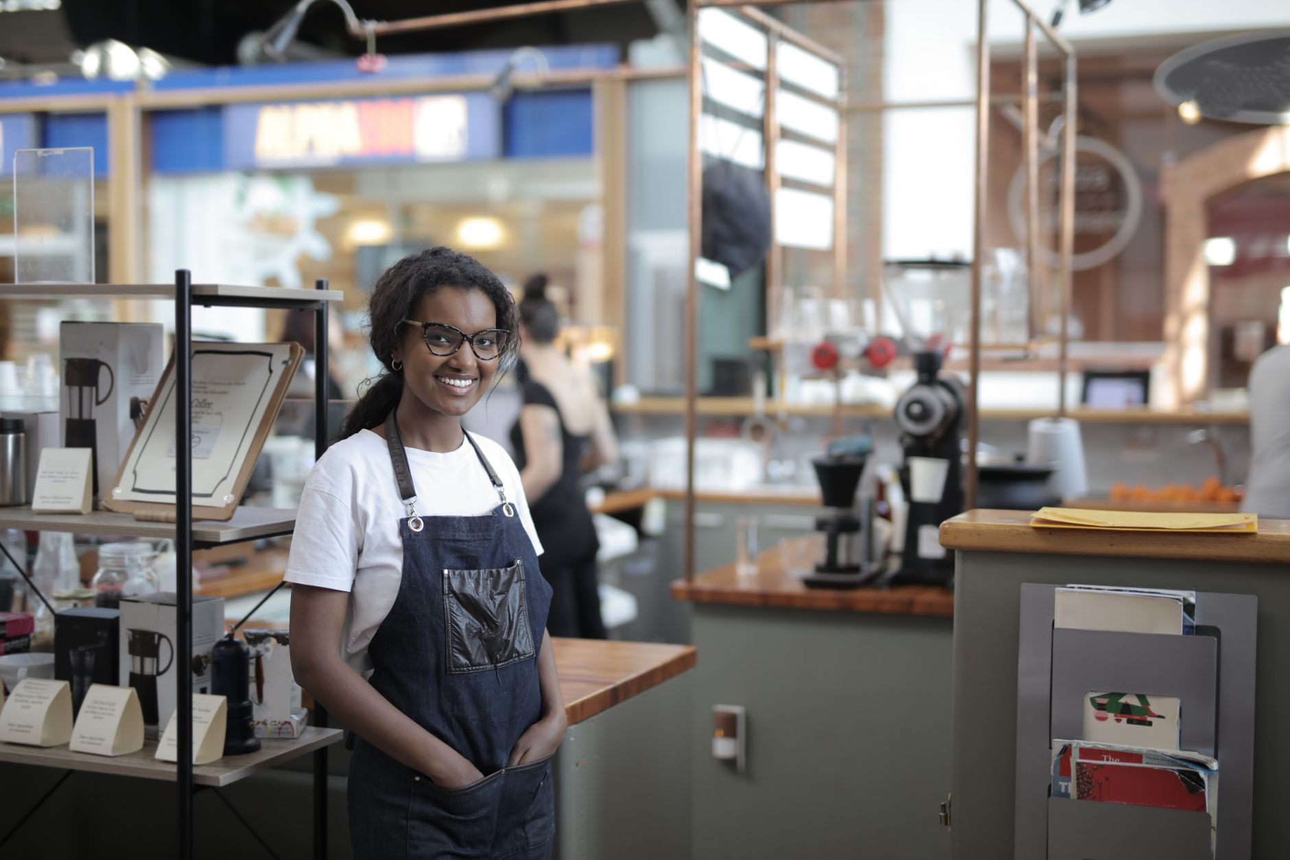 A small business owner standing confidently in their own workspace