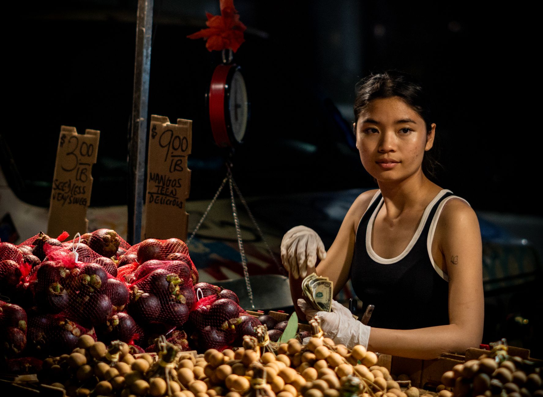 A market stall owner checking something on their phone between customers