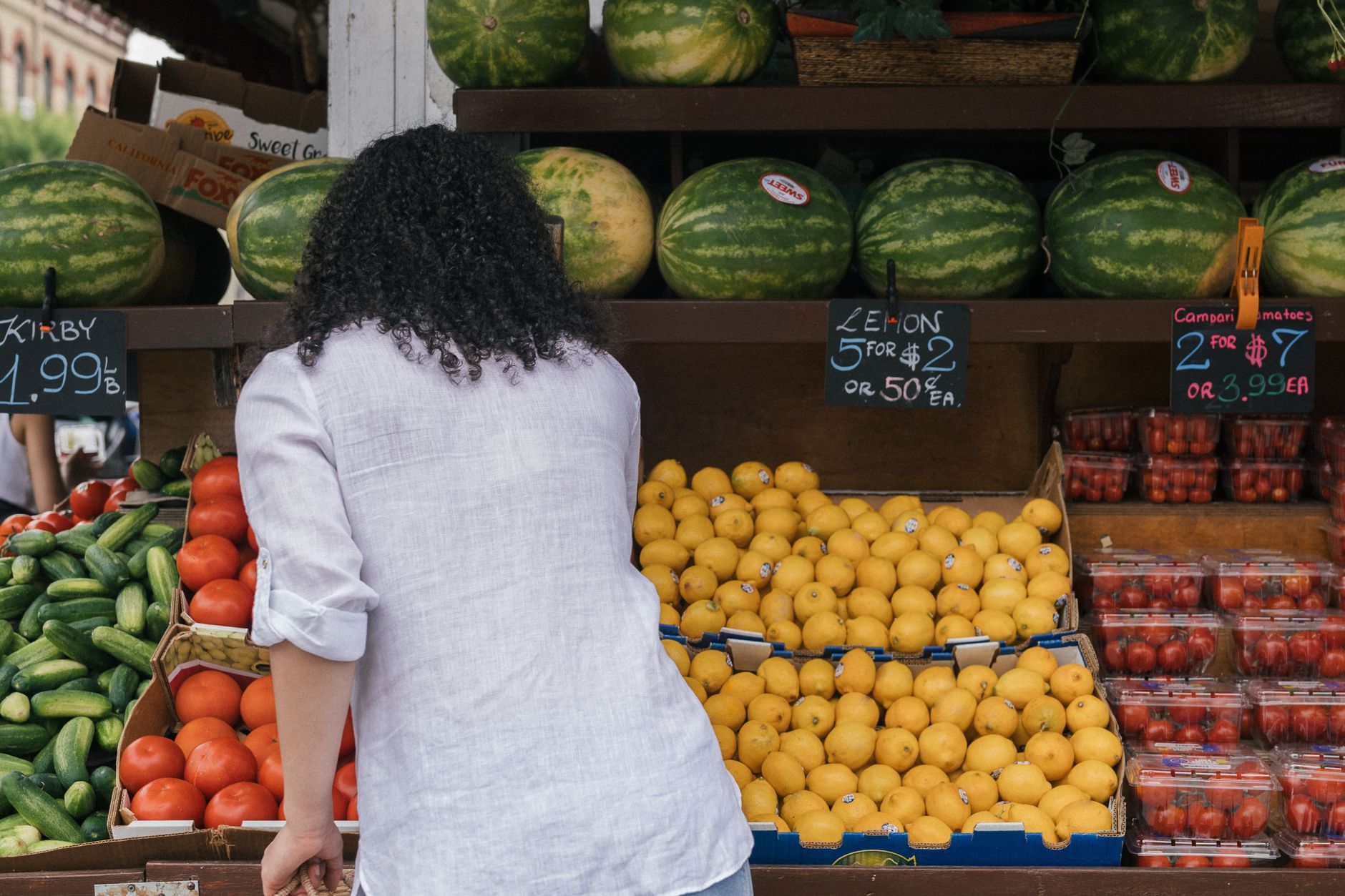 A shopper weighing up spending carefully between two local businesses