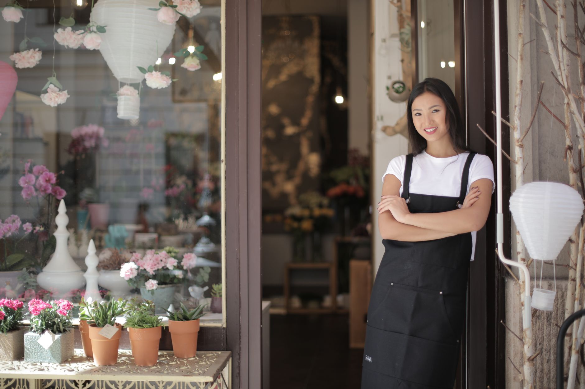 A small business founder standing confidently in their business at day's end