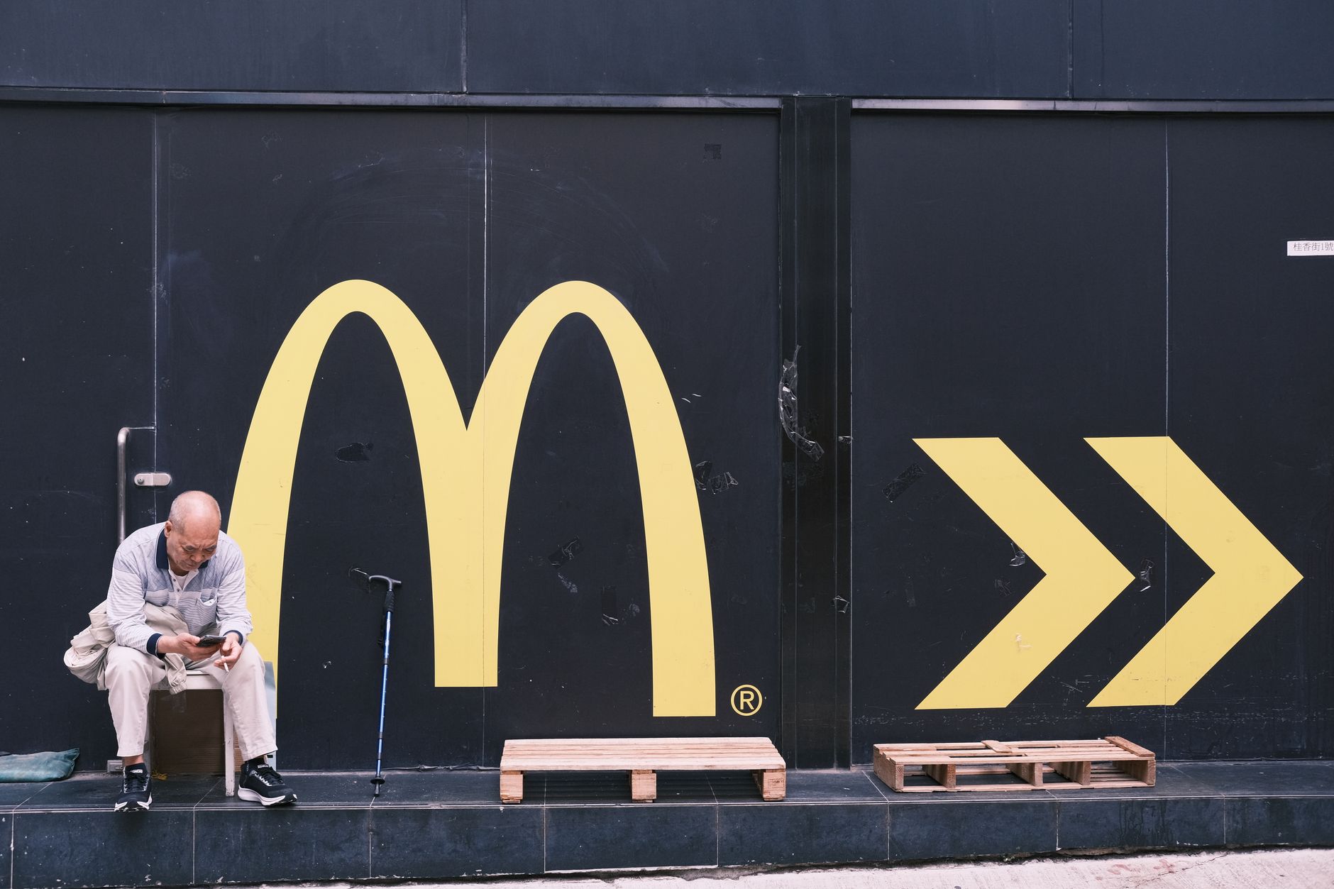 A shop owner maintaining a consistent, recognisable sign