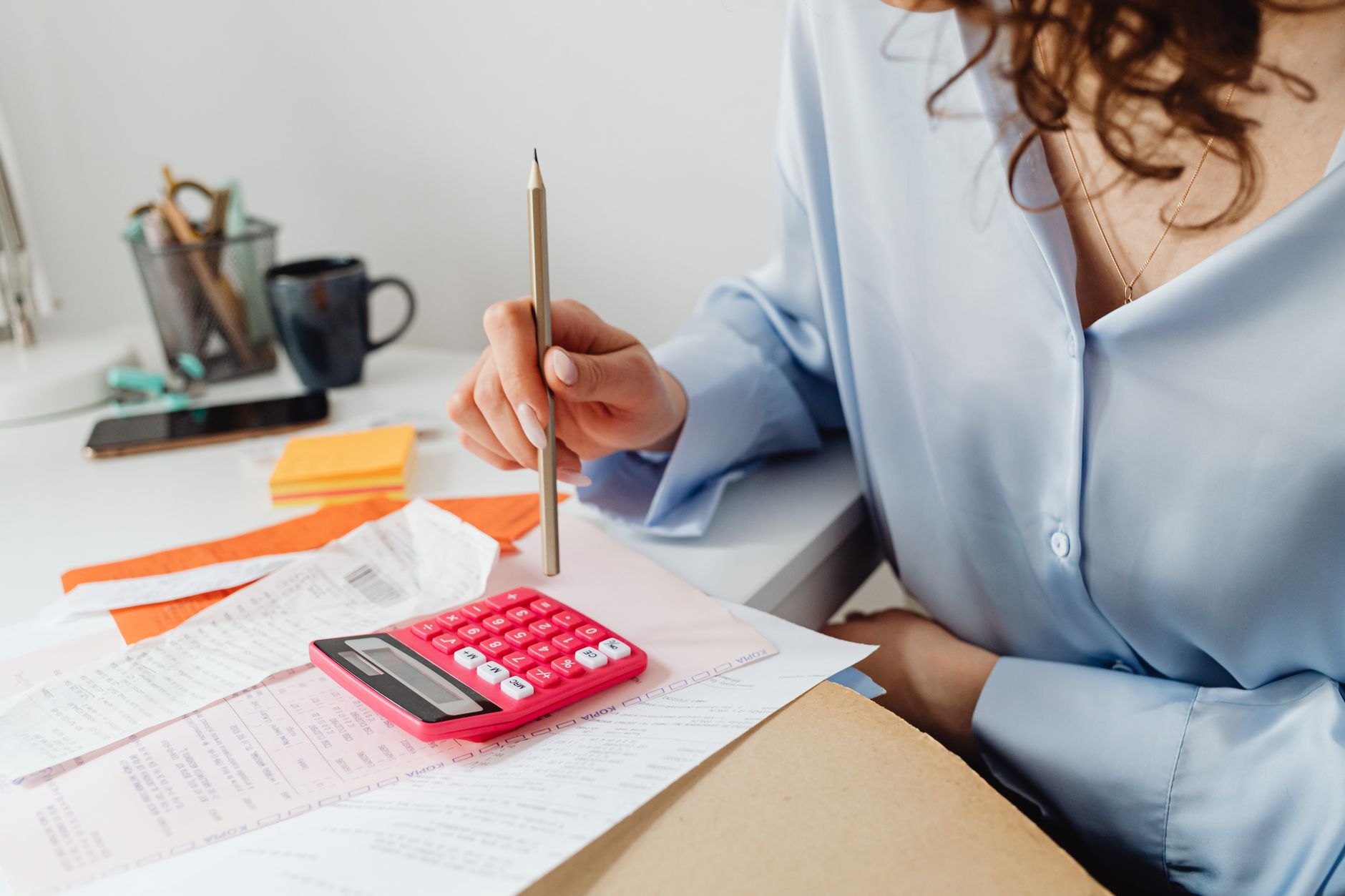 A bookkeeper writing client correspondence in a calm, plain style