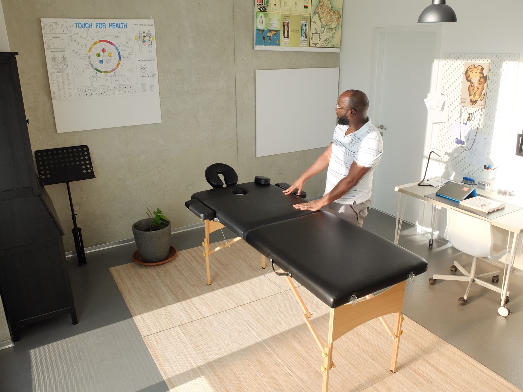 A massage therapist greeting a client at the start of a session