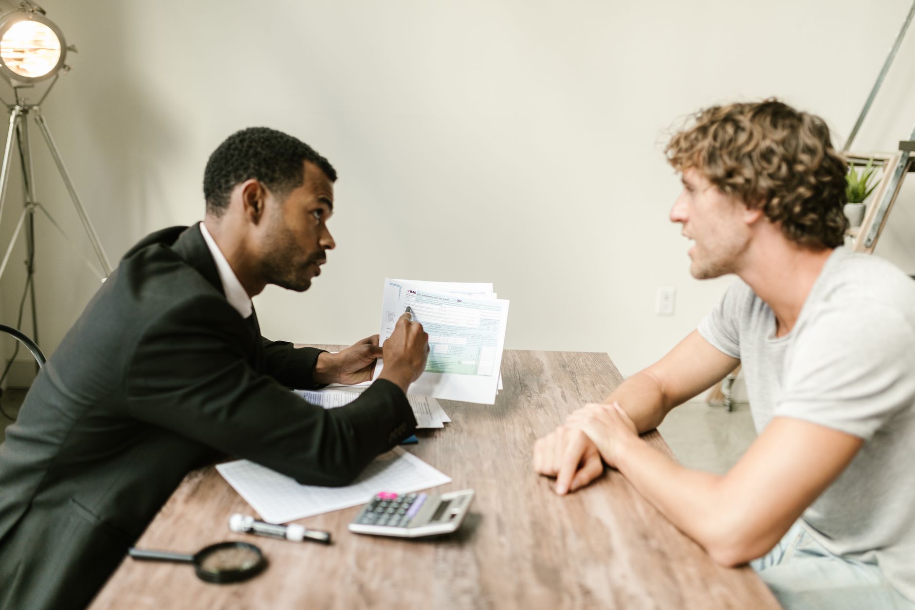 A bookkeeper meeting with a small business client over paperwork
