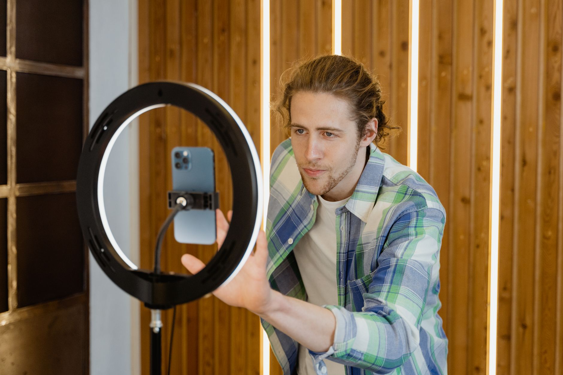 A person filming by a window using natural light for a simple setup
