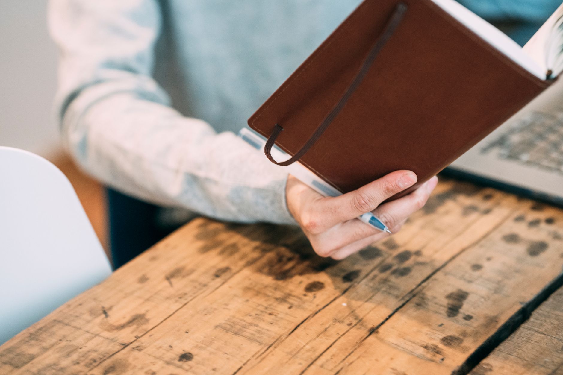 A business owner writing out a simple three month video plan in a diary