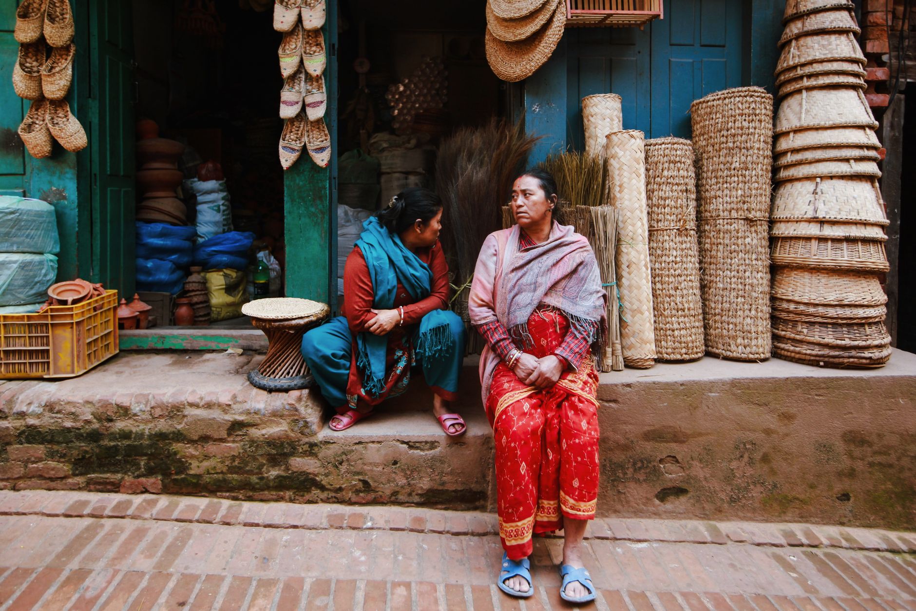 Two neighbours talking outside a local shop