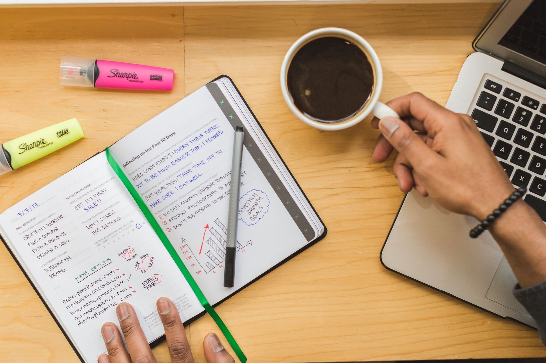 A person sitting down to plan their marketing in a notebook