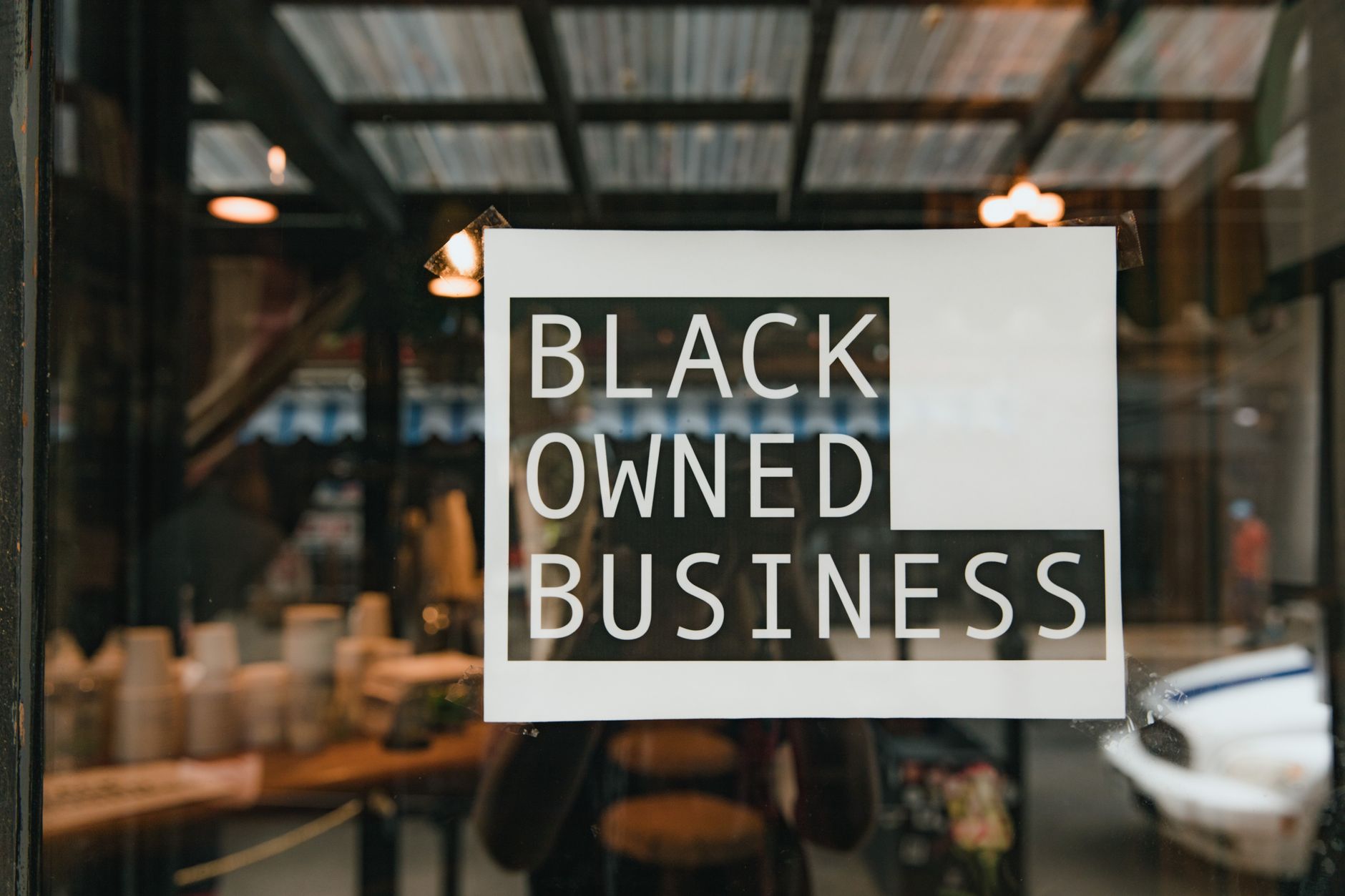 A small business owner setting up a consistent branded shopfront
